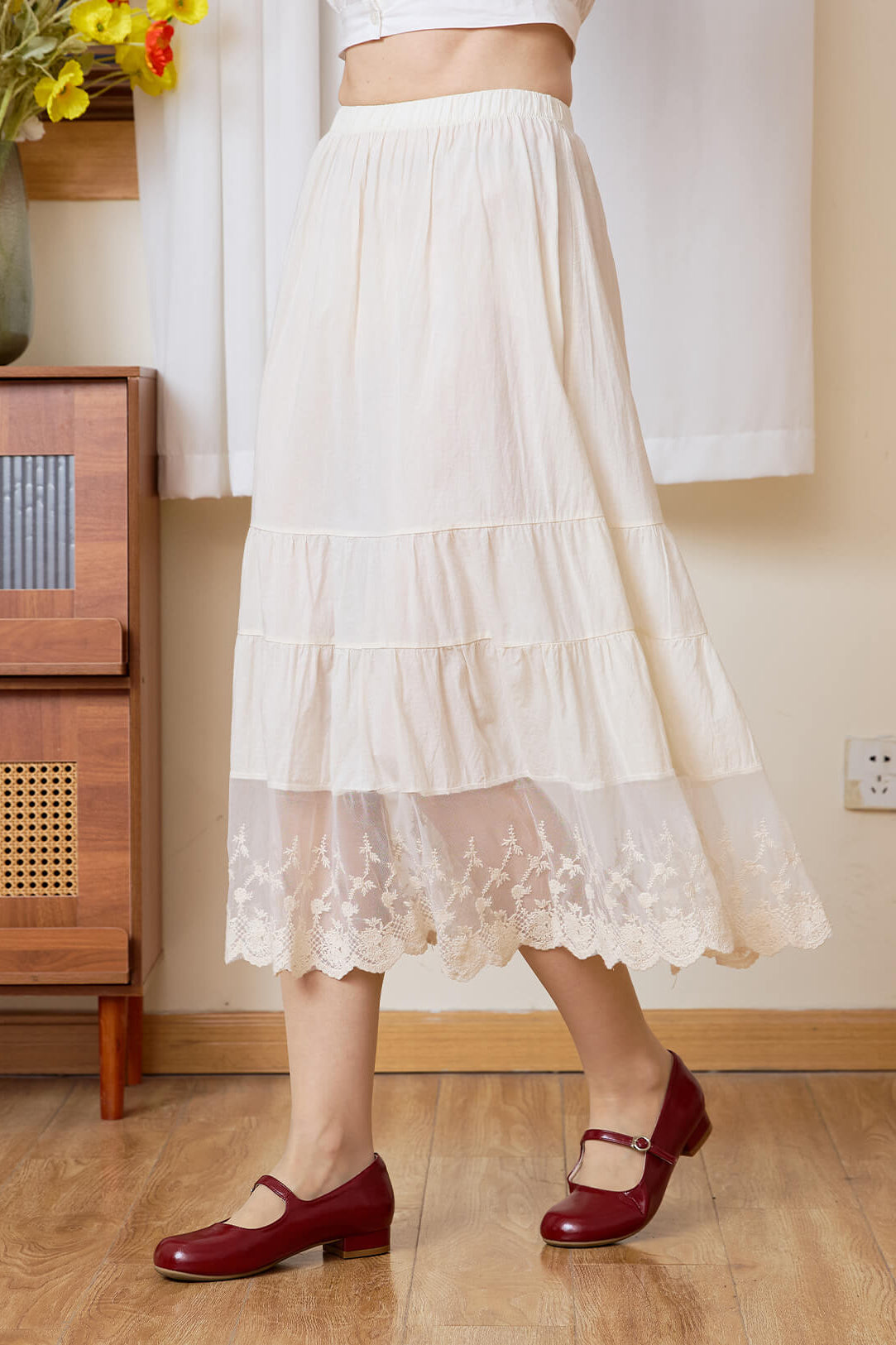 Side close-up of Sueasyretro cream cotton skirt extender showing the tiered panels and lace.