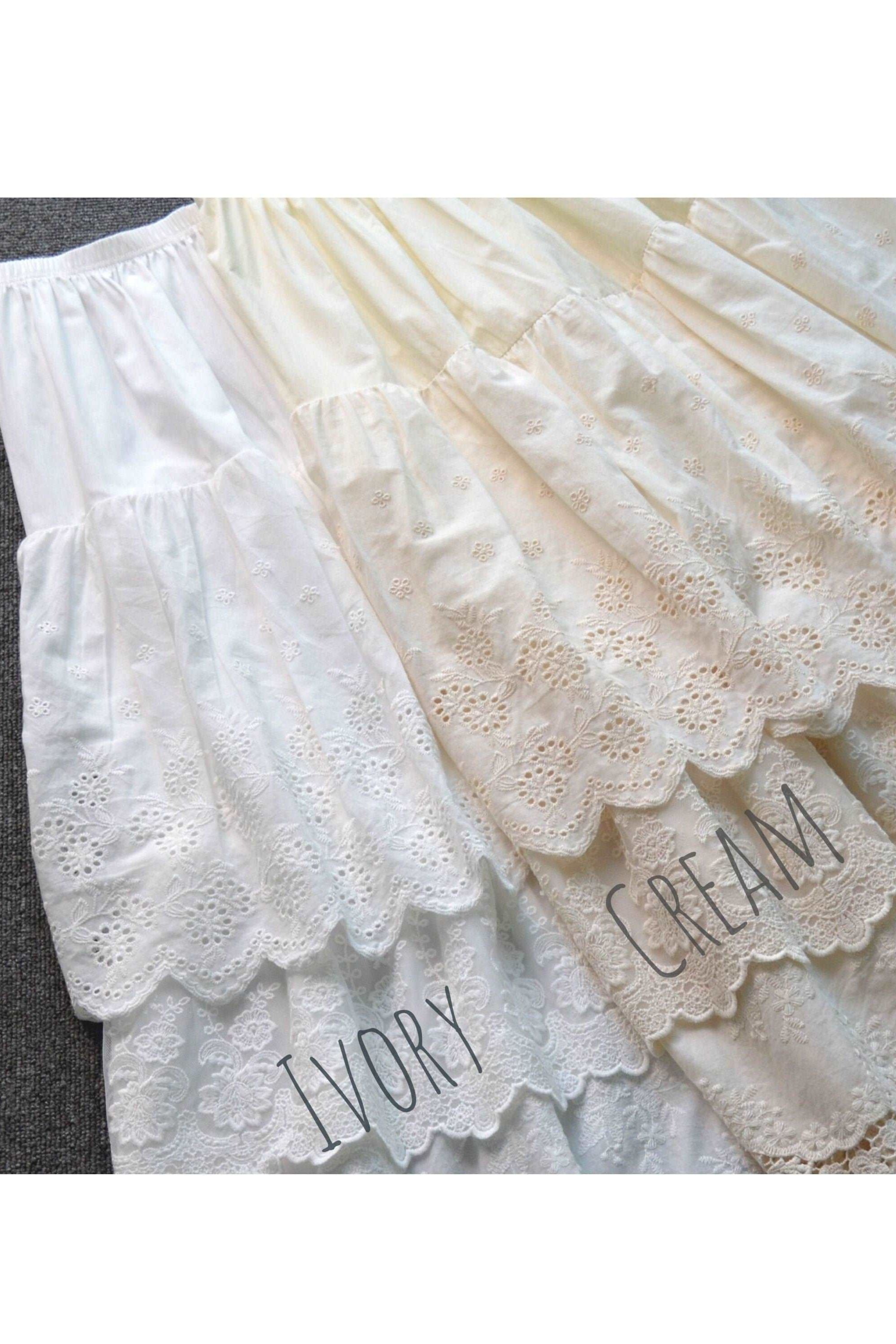 Color comparison of the tiered lace cotton petticoat, showing both the Ivory and Cream color options side-by-side to highlight the fabric details.