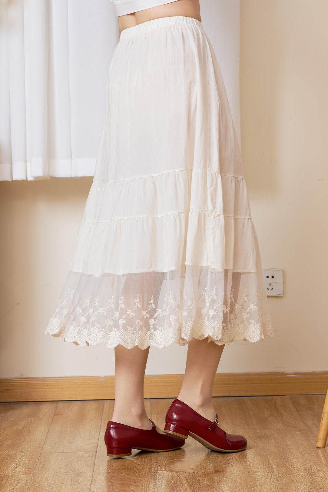 Sueasyretro cream cotton A-line skirt extender, side view showing the tiered lace hem in motion
