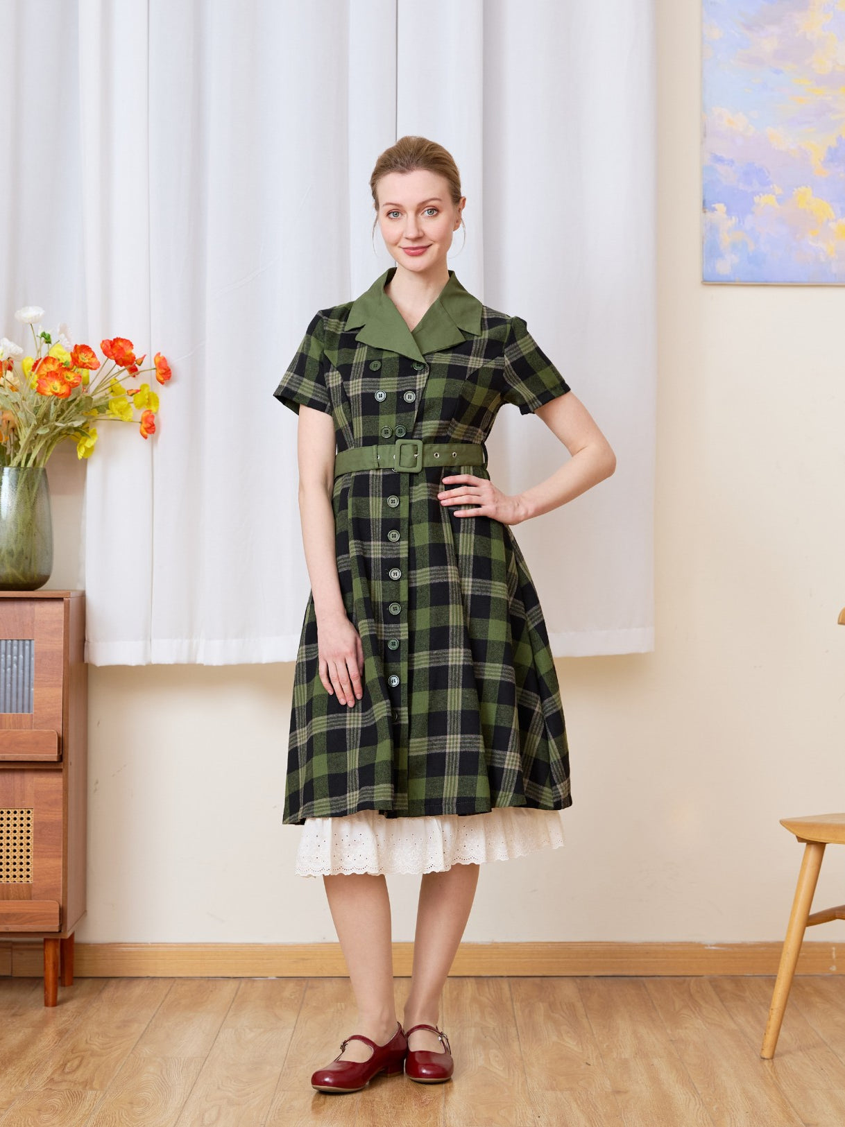Cream cotton petticoat with floral lace trim peeking under a plaid dress, vintage-inspired layering for a retro look.