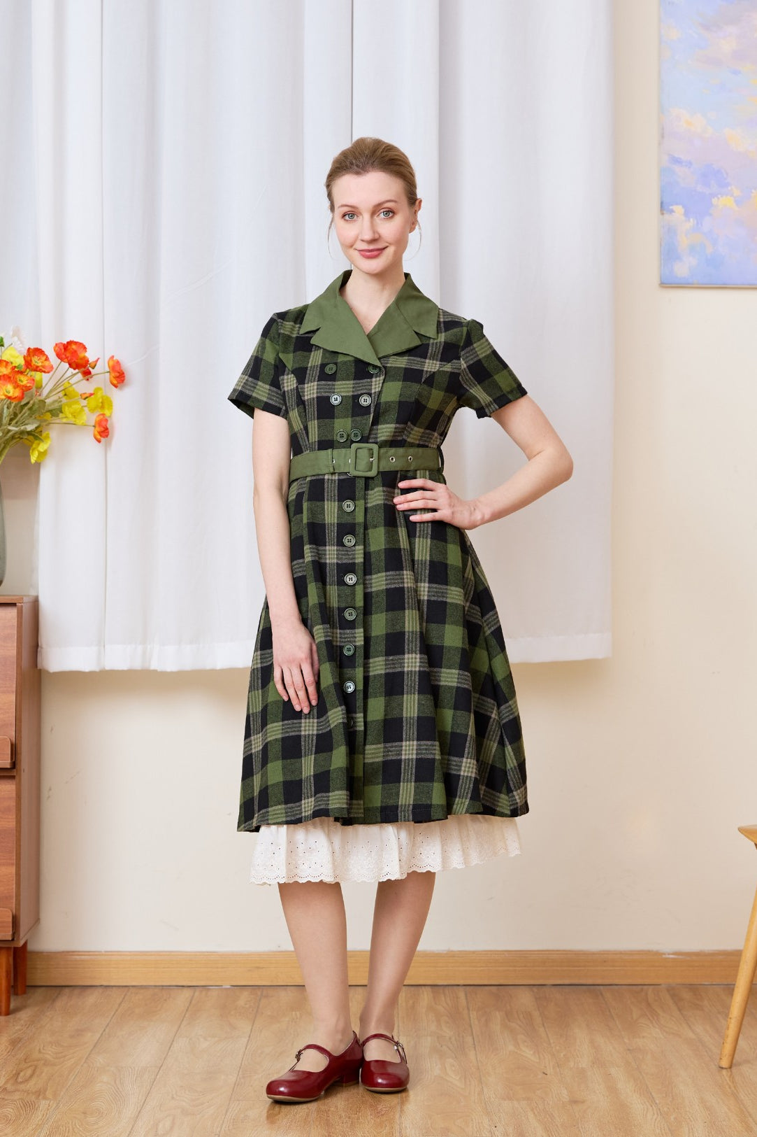 Cream cotton petticoat with floral lace trim peeking under a plaid dress, vintage-inspired layering for a retro look.