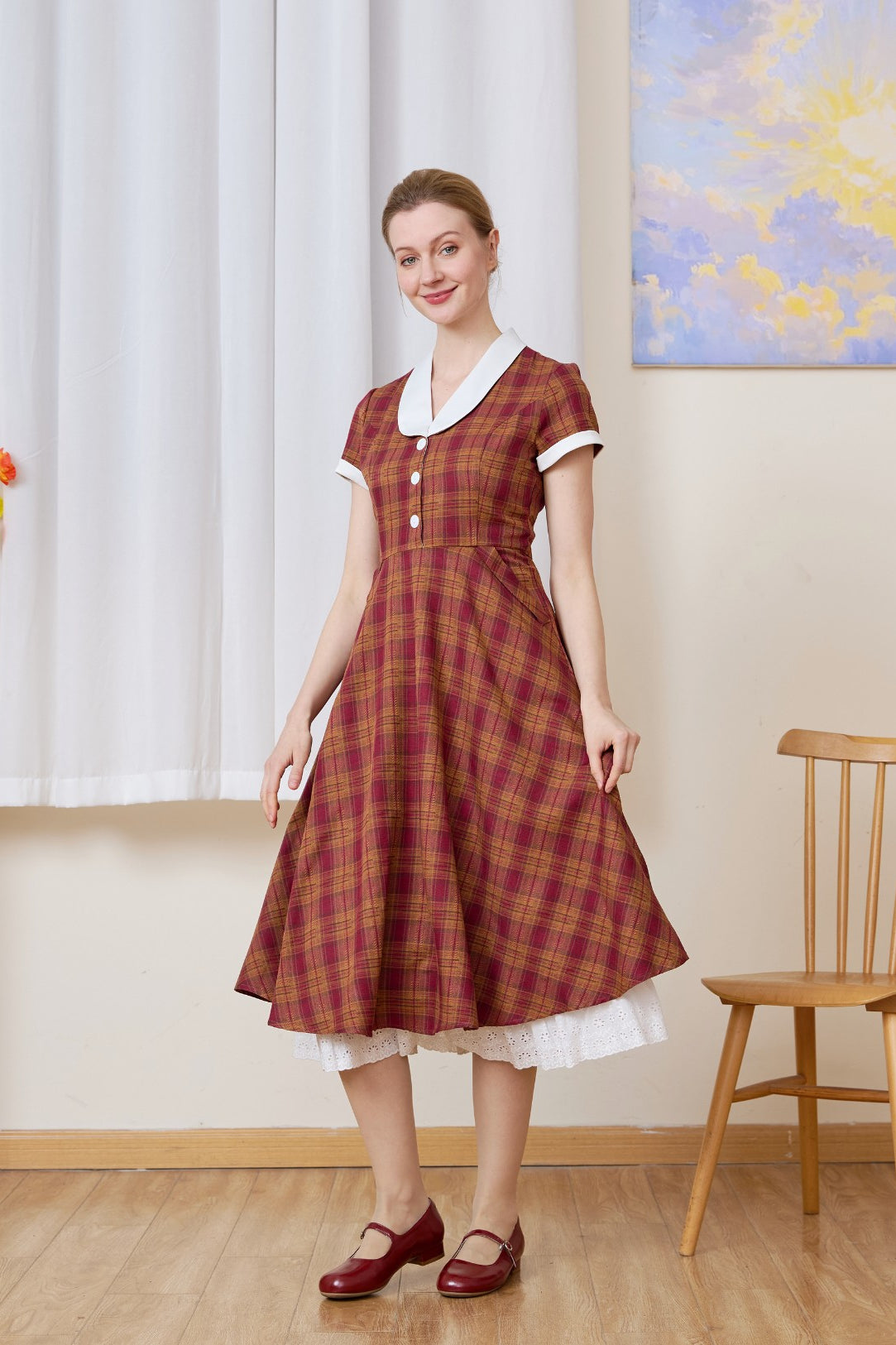 The long half slip layered under a red plaid dress. This cotton Petticoat adds vintage volume and lace detail.