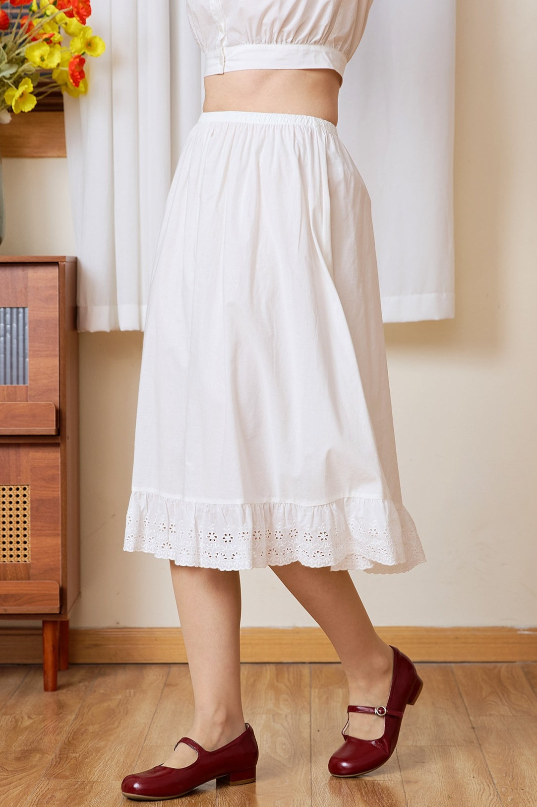 Side profile of the long half slip. A static-free cotton Petticoat with a geometric medallion lace edge.