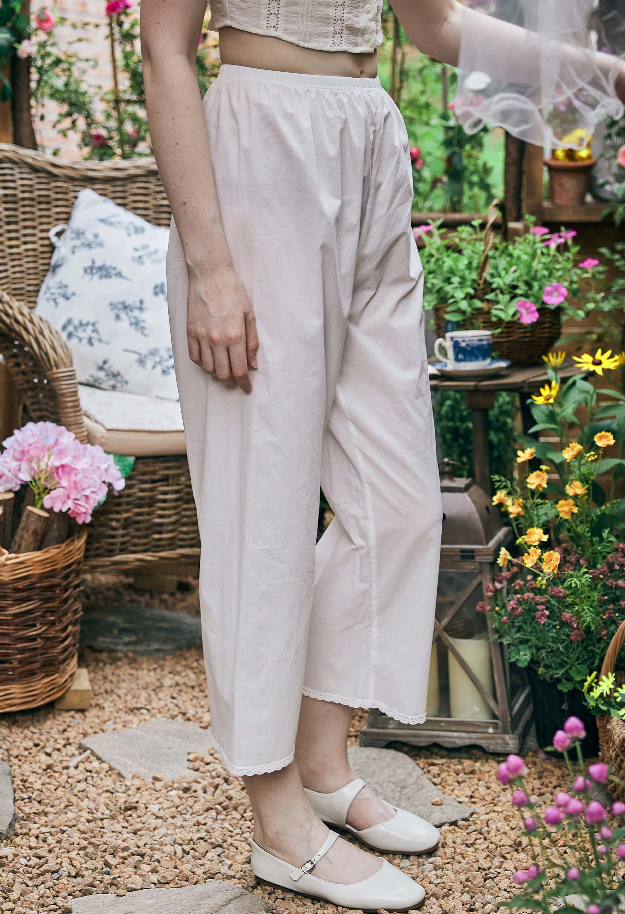 Side close-up of Sueasyretro white bloomer pants with delicate lace hem, comfortable cotton Pajamas Pants for lounging.