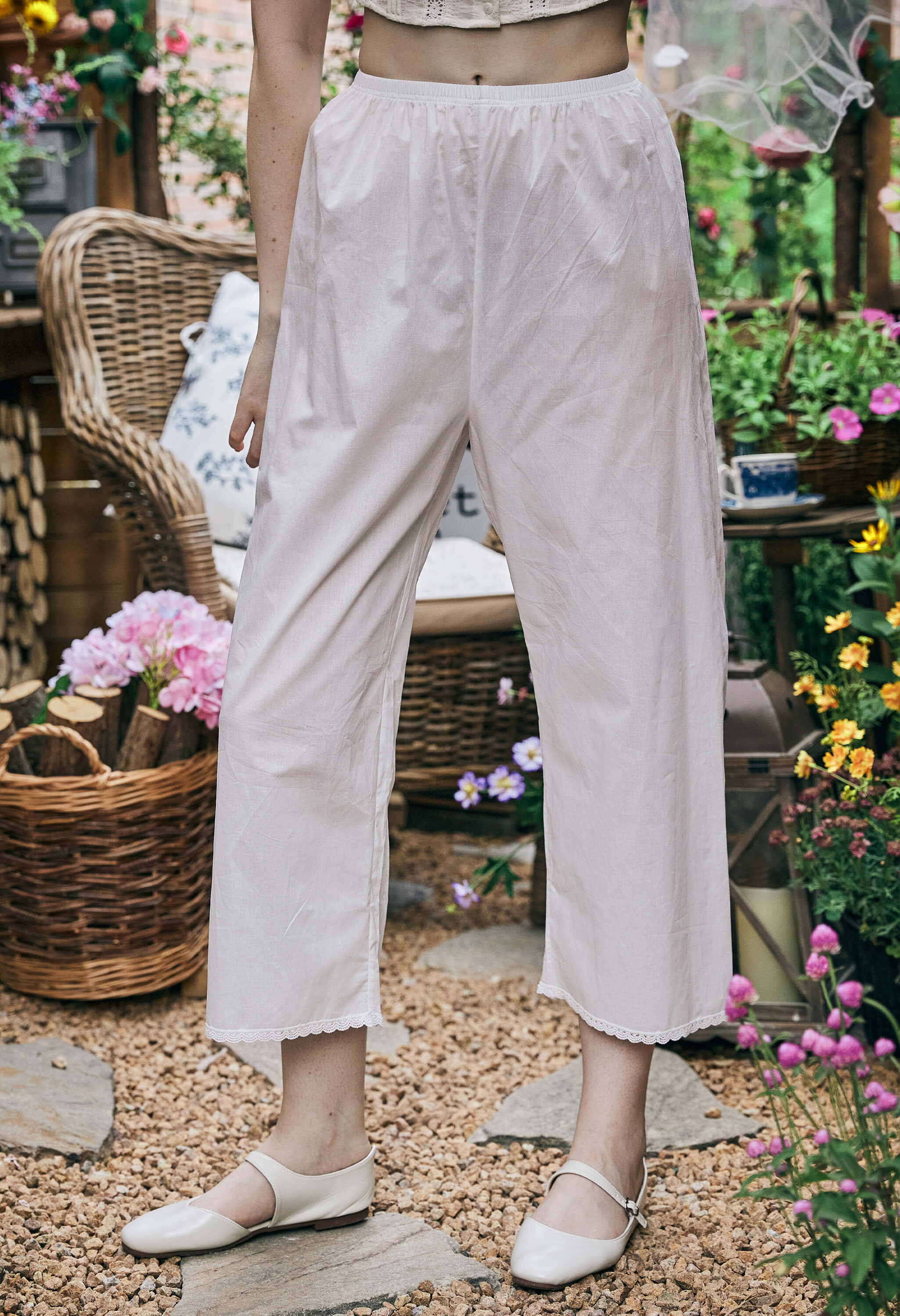 Front view of Sueasyretro long bloomers. Wide-leg white cotton Pettipants with elastic waist and lace trim at the hem.