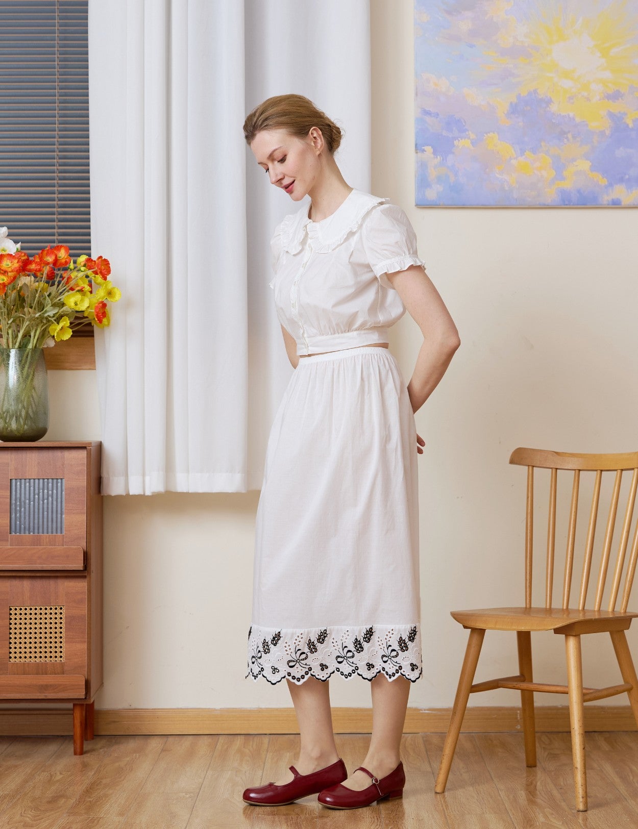 Profile view of the white cotton Petticoat showcasing the detailed blackwork embroidery.