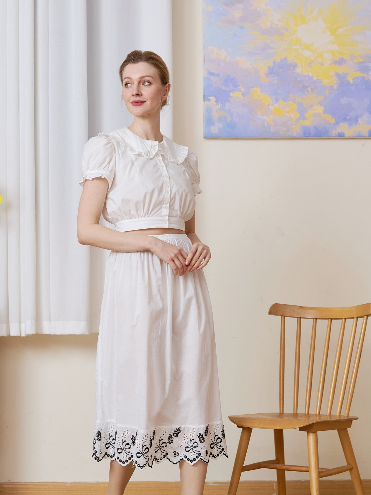 Front view of the midi white cotton Petticoat highlighted by Tudor bluework embroidery.