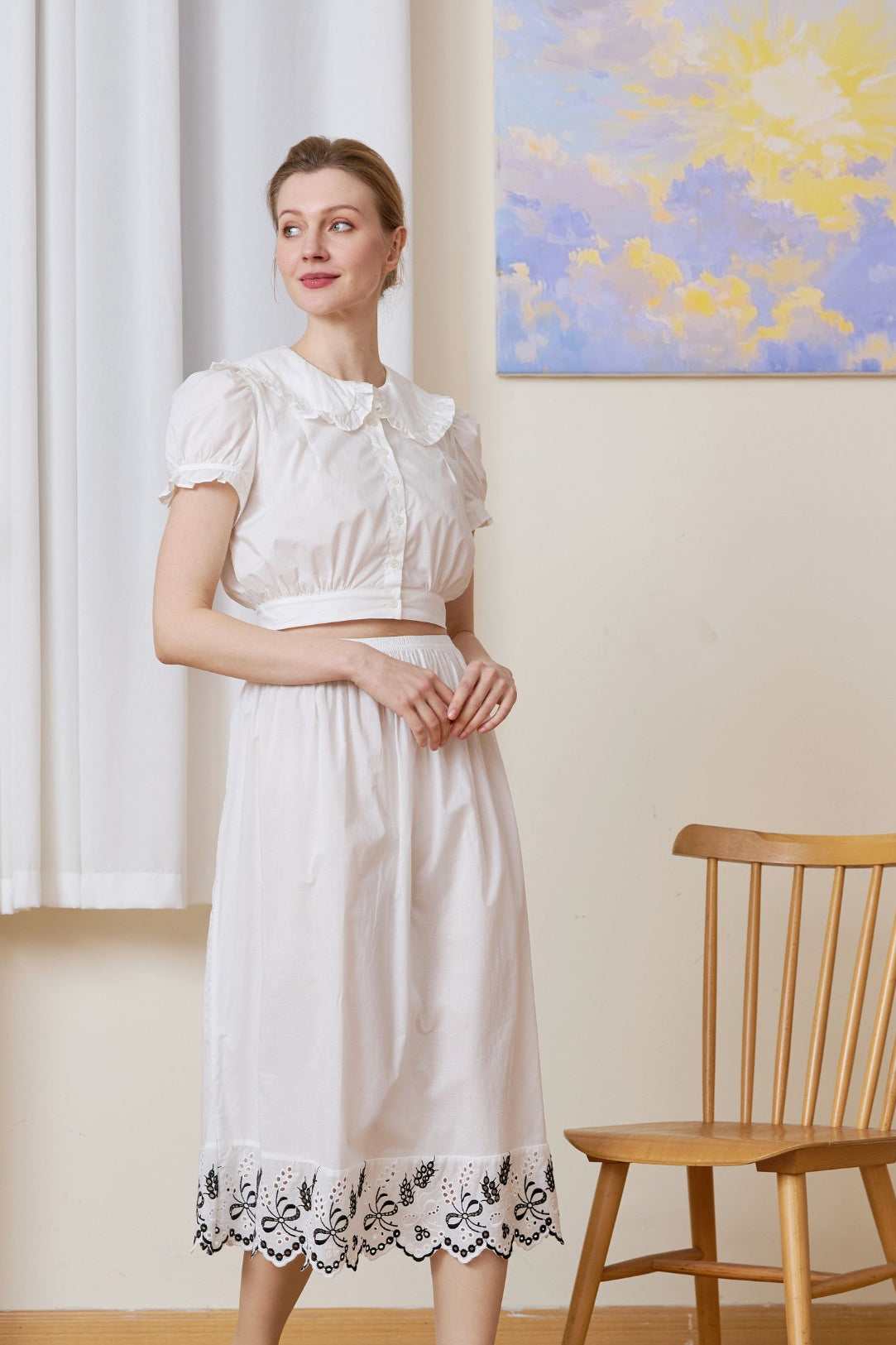 Front view of the midi white cotton Petticoat highlighted by Tudor bluework embroidery.