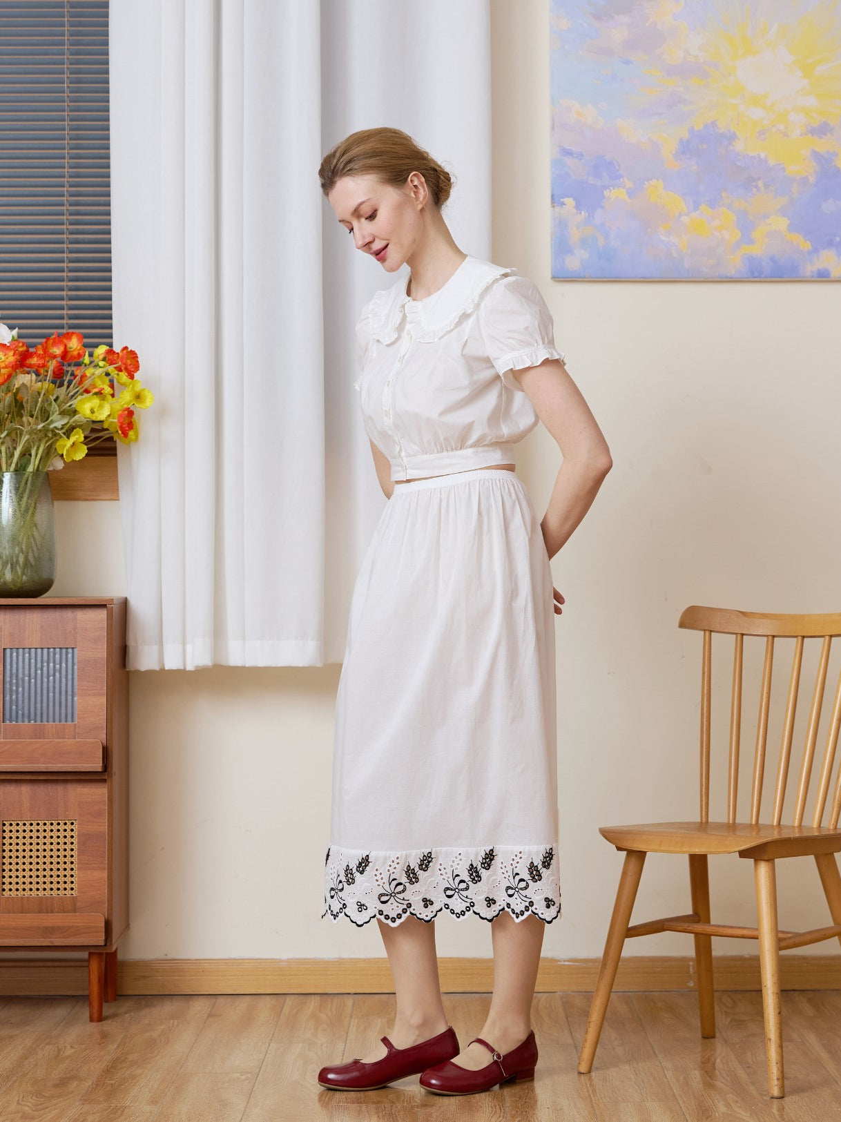 Profile view of the white cotton Petticoat showcasing the detailed bluework embroidery.