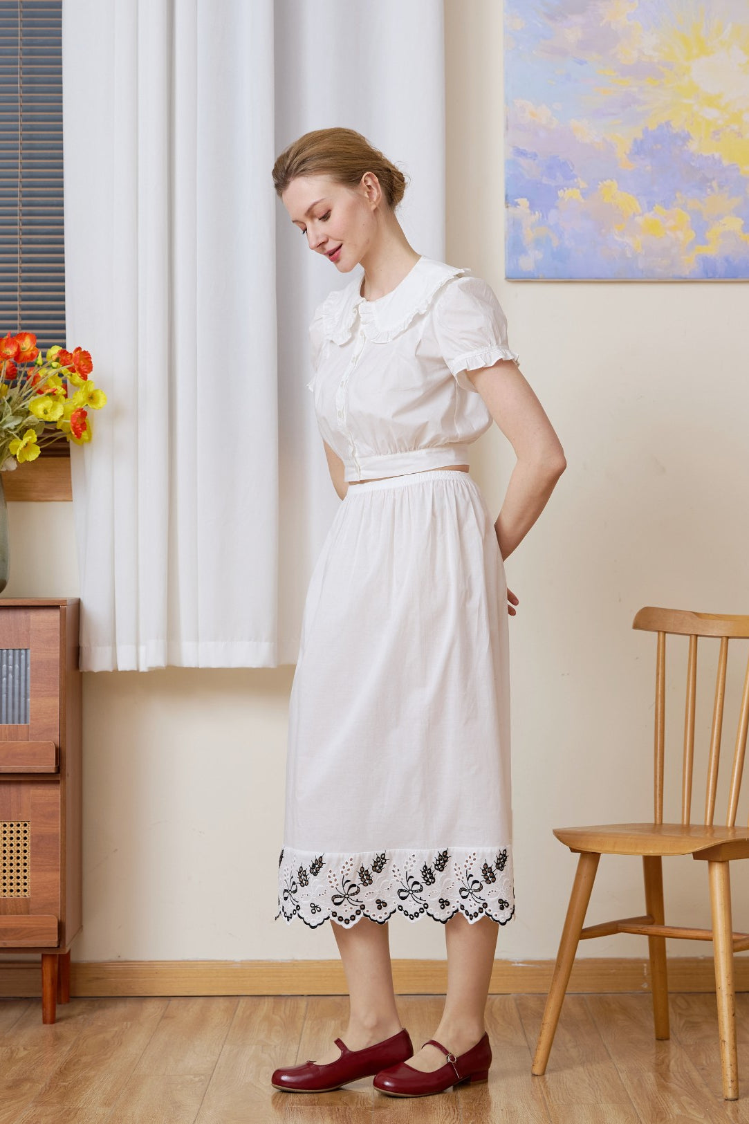Profile view of the white cotton Petticoat showcasing the detailed bluework embroidery.