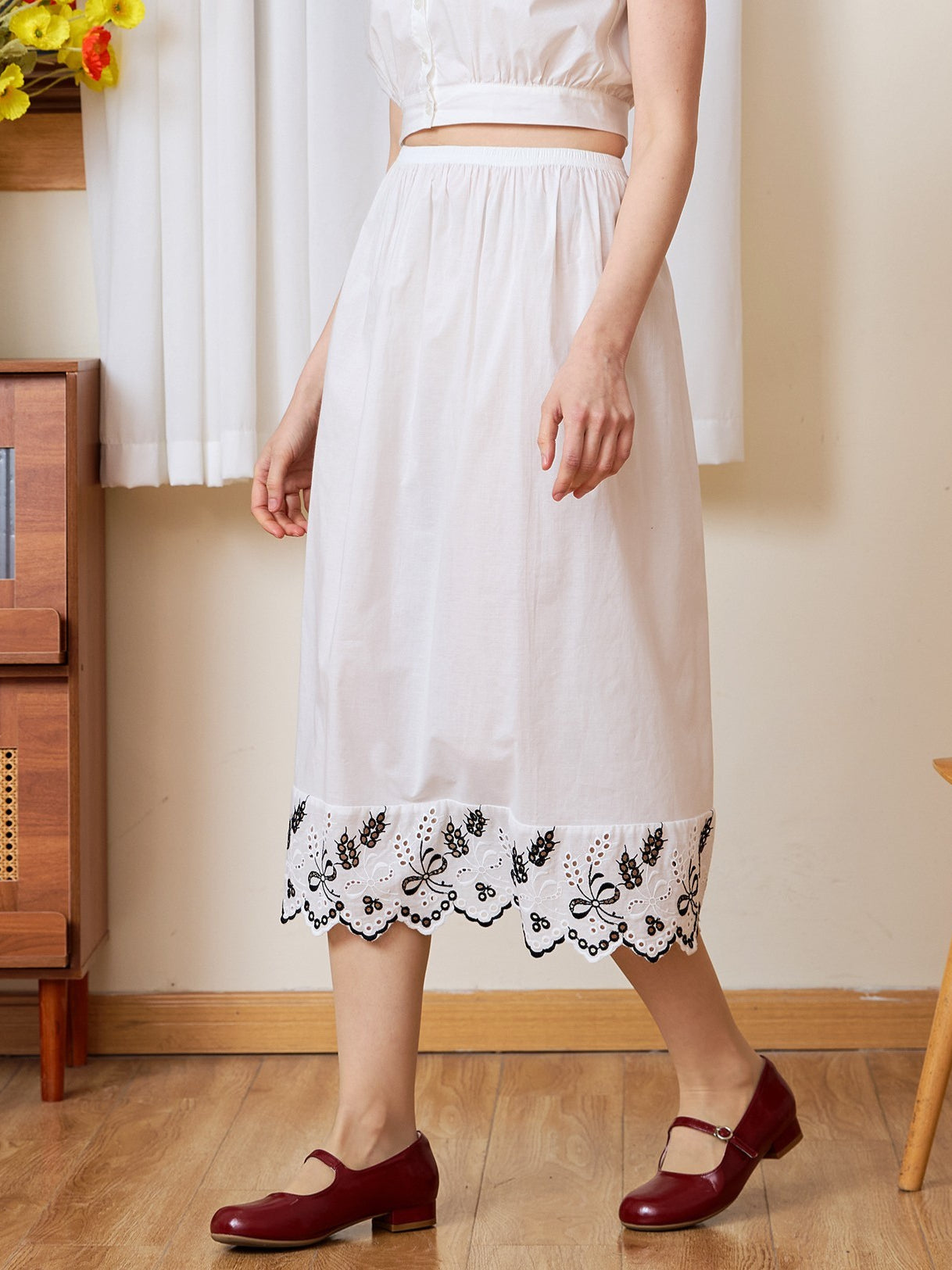 Waist-down view of the white cotton Petticoat, designed to feature Tudor bluework.