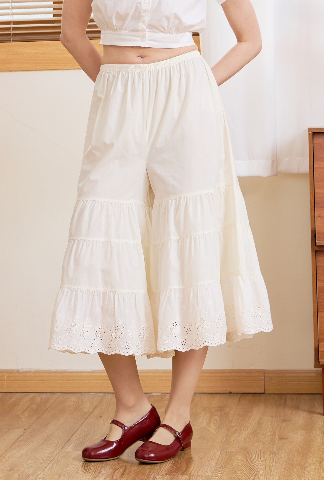 Front view of cream cotton bloomers for women. These vintage bloomer pants feature a flexible elastic waist and tiers.