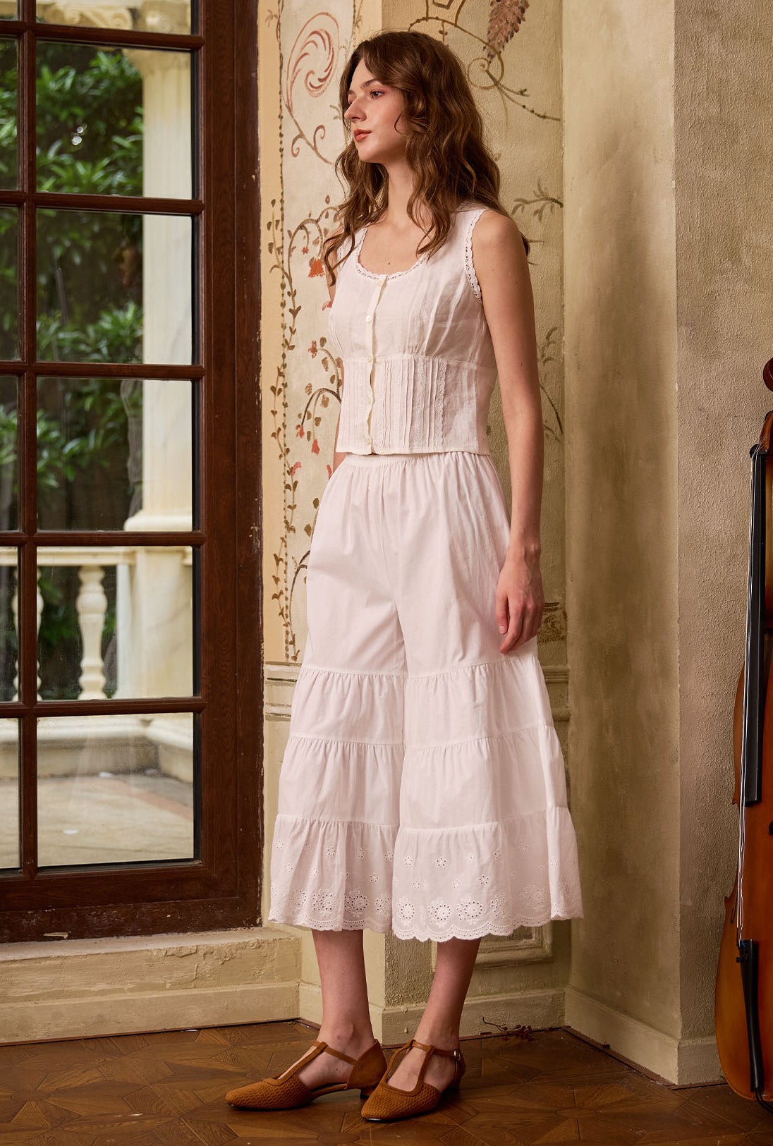 Angled view of white cotton bloomers for women. These tiered bloomer pants offer retro charm and breathable comfort.