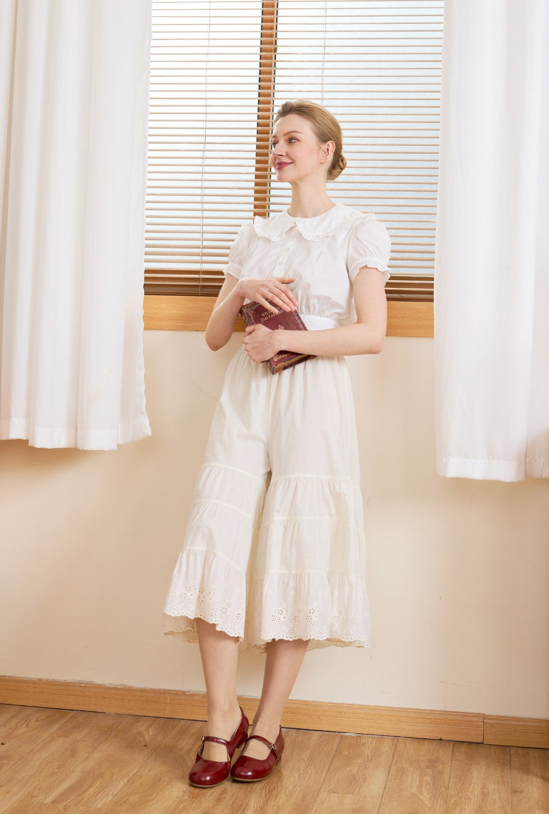 Full body pose in cream cotton bloomers for women. Vintage bloomer pants crafted from pure cotton for everyday comfort.