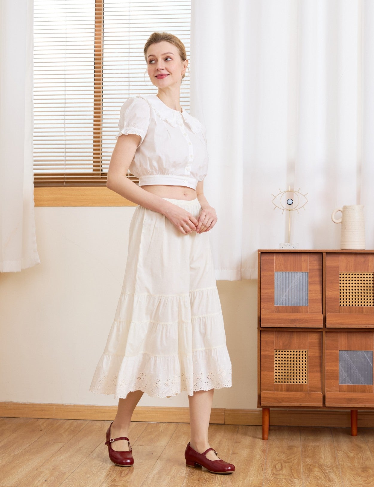 Angled view of the cream wide leg cotton bloomers. Perfect bloomer pants to wear alone or layer under a midi skirt.