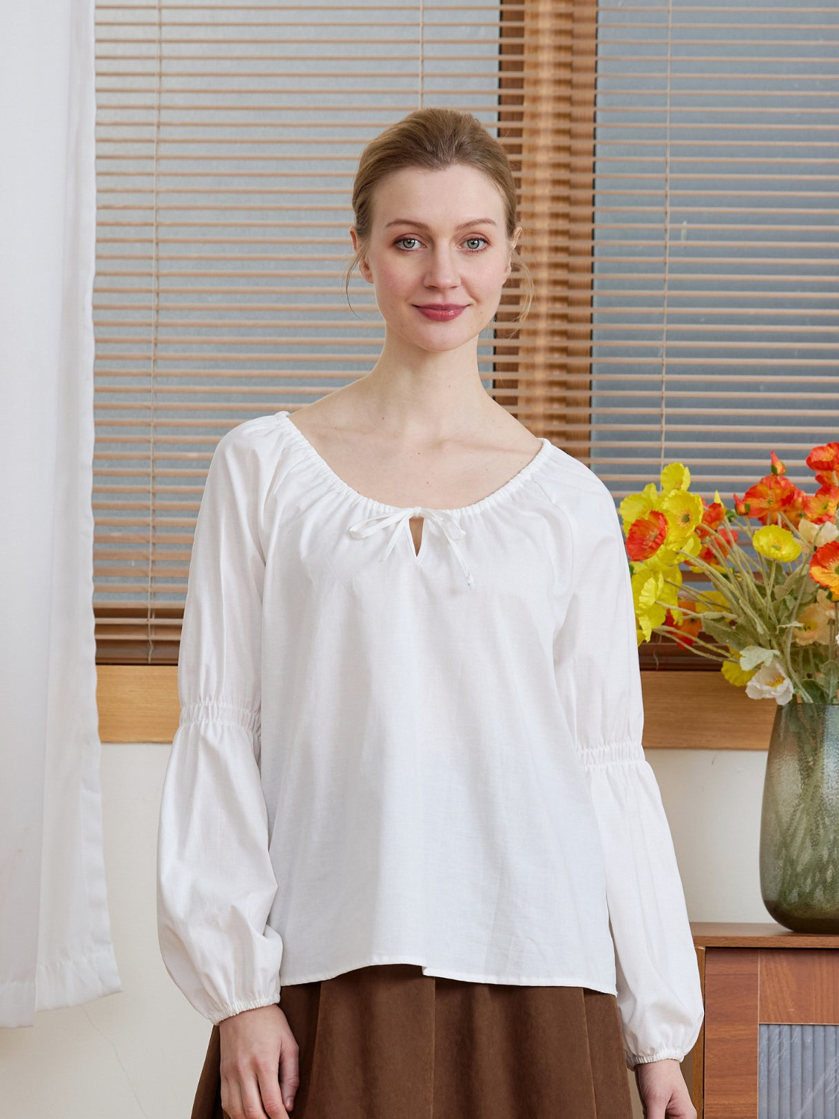 Front view of the Ivory Renaissance Cotton Blouse with long puff sleeves and a drawstring neckline