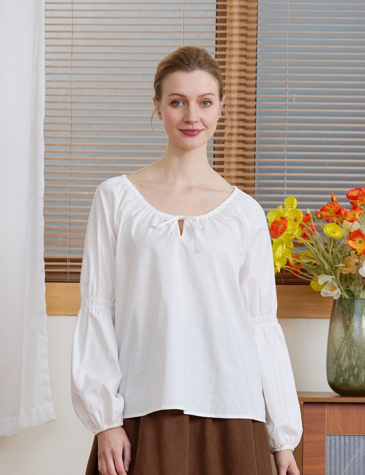 Front view of the Ivory Renaissance Cotton Blouse with long puff sleeves and a drawstring neckline