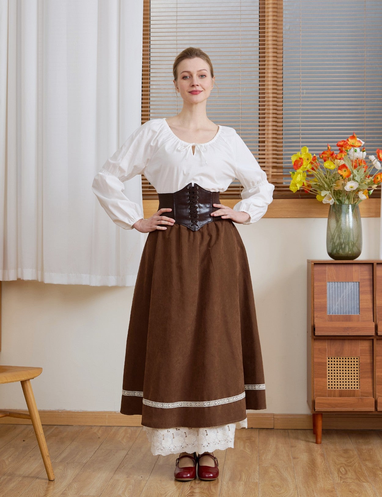 The Ivory Renaissance Cotton Blouse styled with a dark brown corset and long skirt for a medieval pirate outfit.