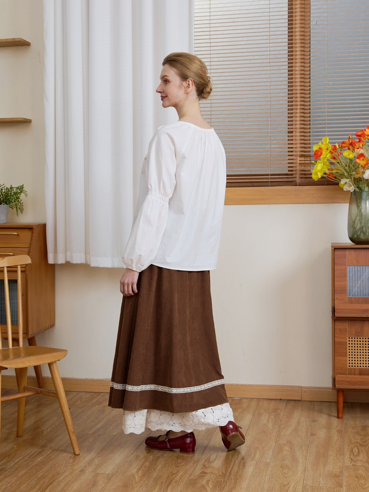 Side and back profile of the Ivory Renaissance Cotton Blouse, demonstrating the draped fit of the puff sleeves.