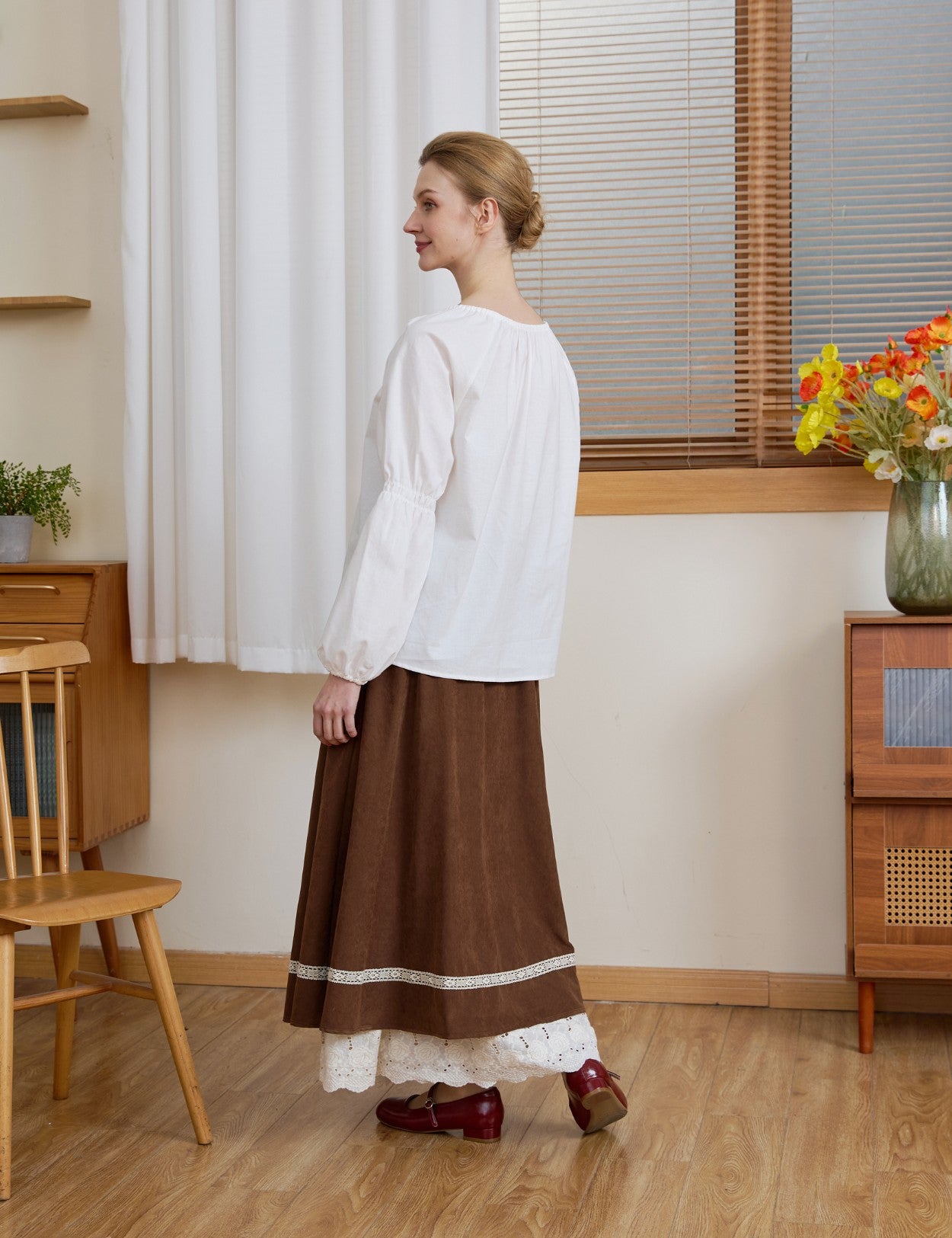 Side and back profile of the Ivory Renaissance Cotton Blouse, demonstrating the draped fit of the puff sleeves.