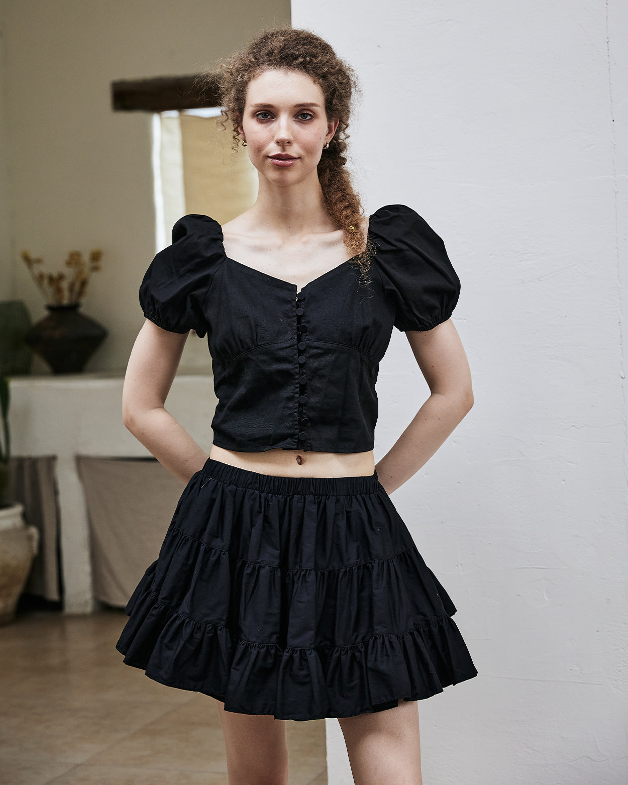 Women's black vintage cotton tiered skort in front view showing high waist design and ruffle hem details