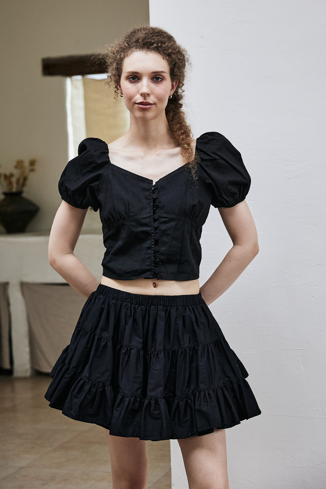Women's black vintage cotton tiered skort in front view showing high waist design and ruffle hem details