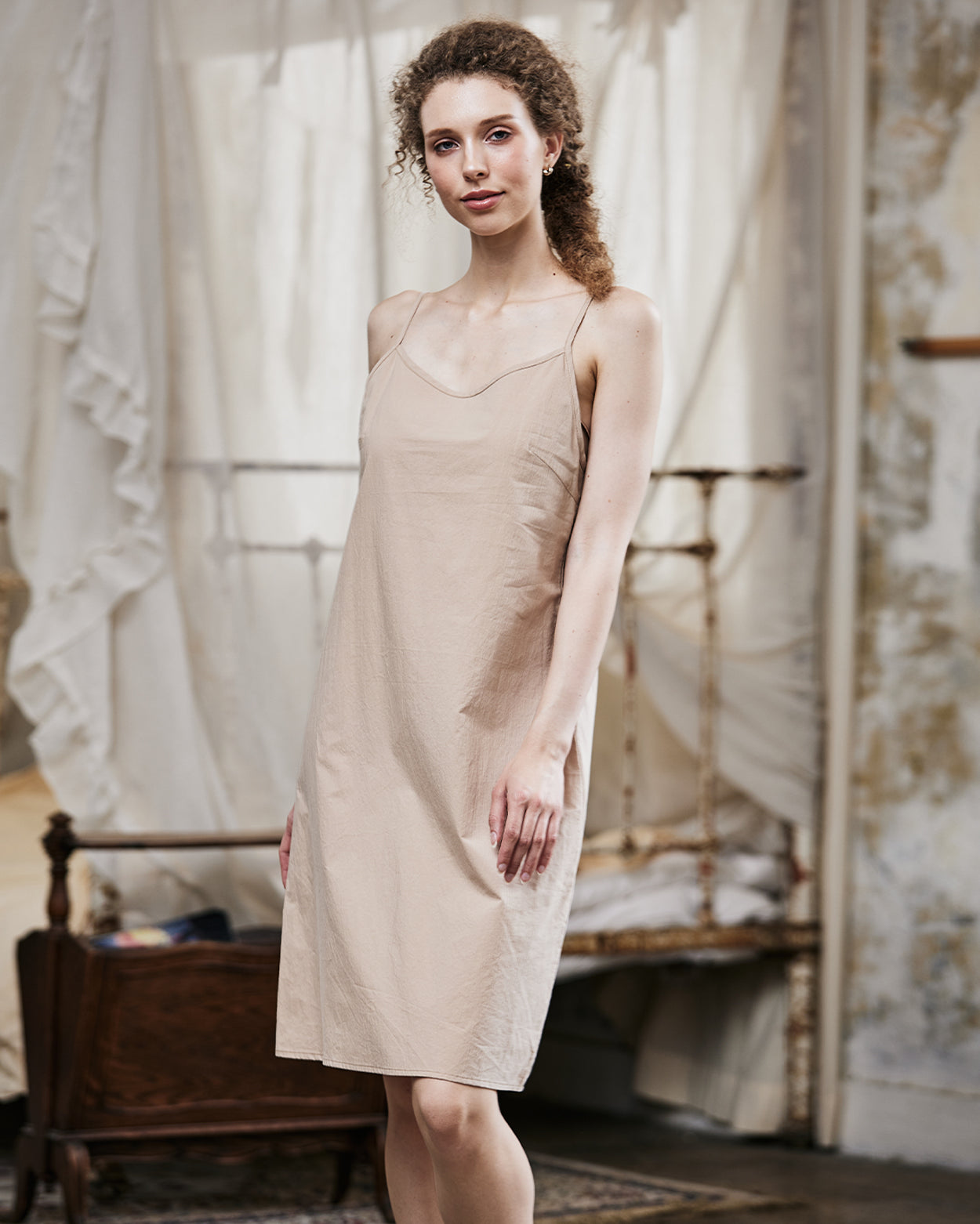 Women's nude cotton full slip with spaghetti straps, showing comfortable fit and classic design