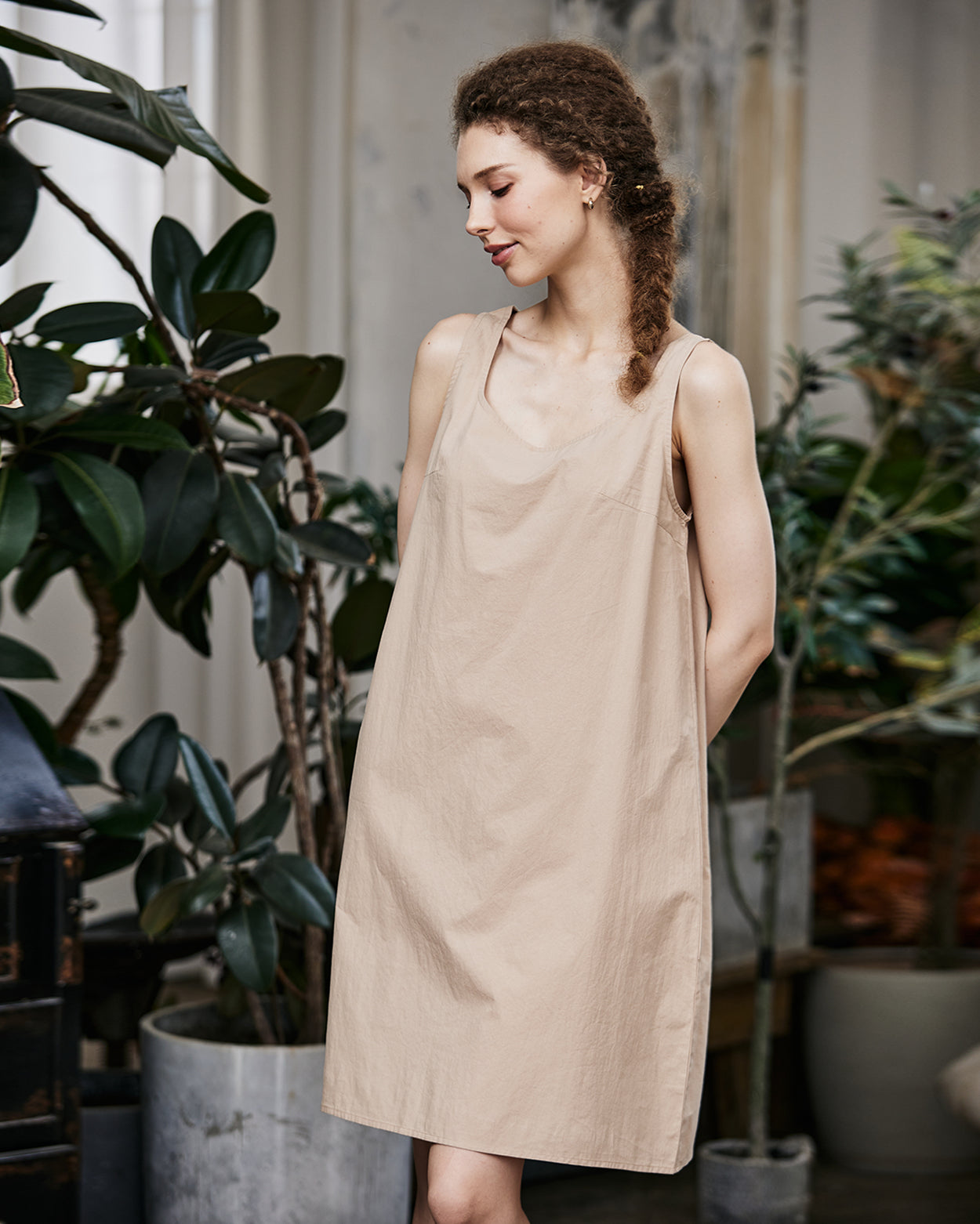 Women's nude cotton full slip with wide straps, showing modesty panel and knee-length design