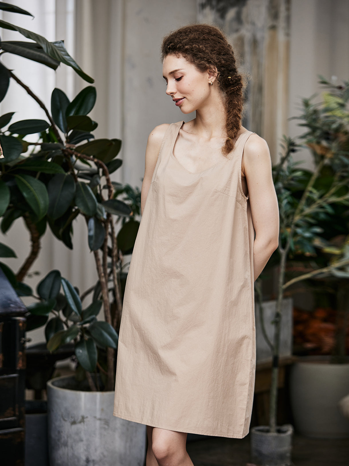 Women's nude cotton full slip with wide straps, showing modesty panel and knee-length design