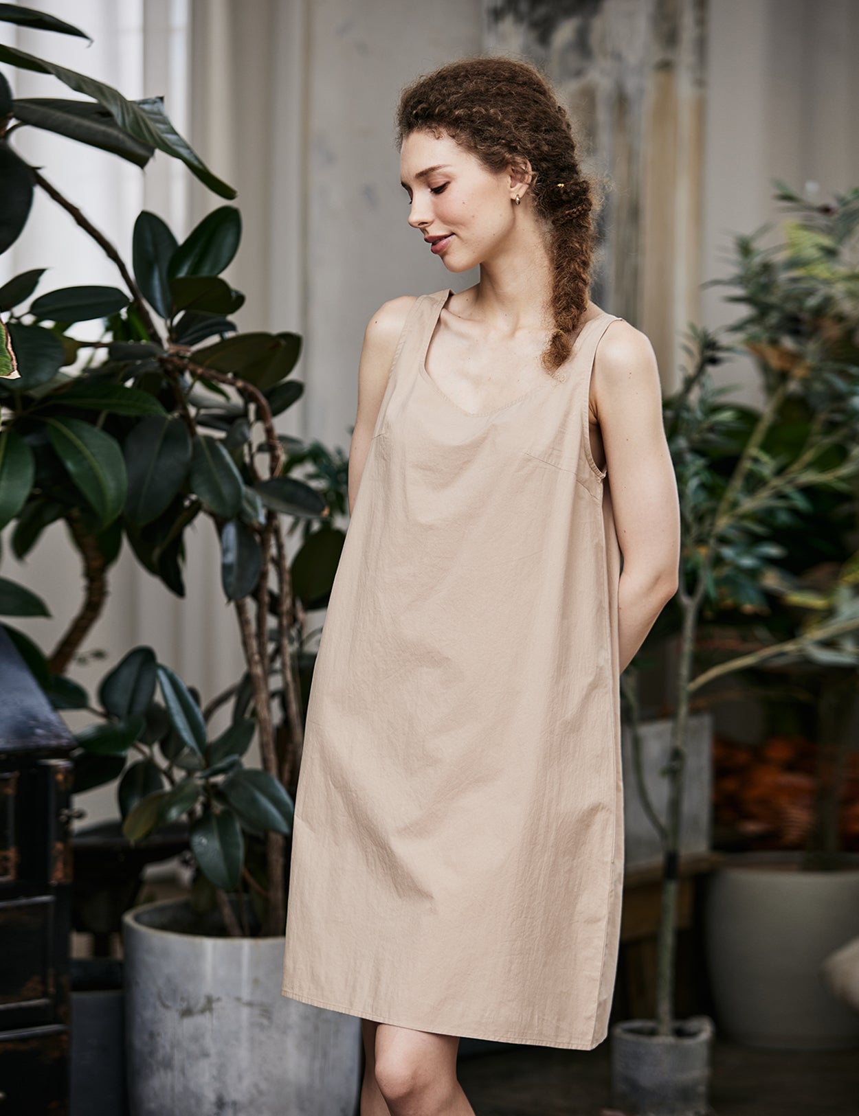 Women's nude cotton full slip with wide straps, showing modesty panel and knee-length design