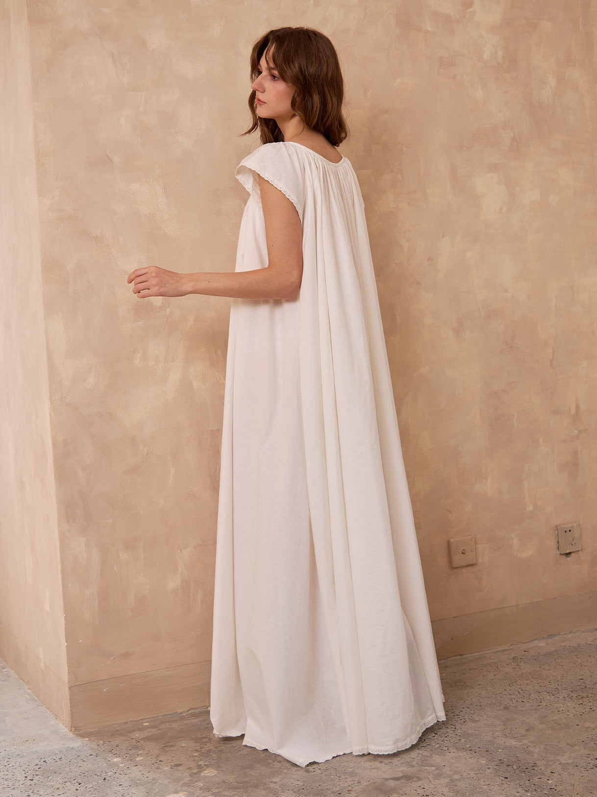 Back view of Sueasyretro ivory Victorian nightgown. Voluminous 100% cotton floor-length nightie with sleeveless lace.
