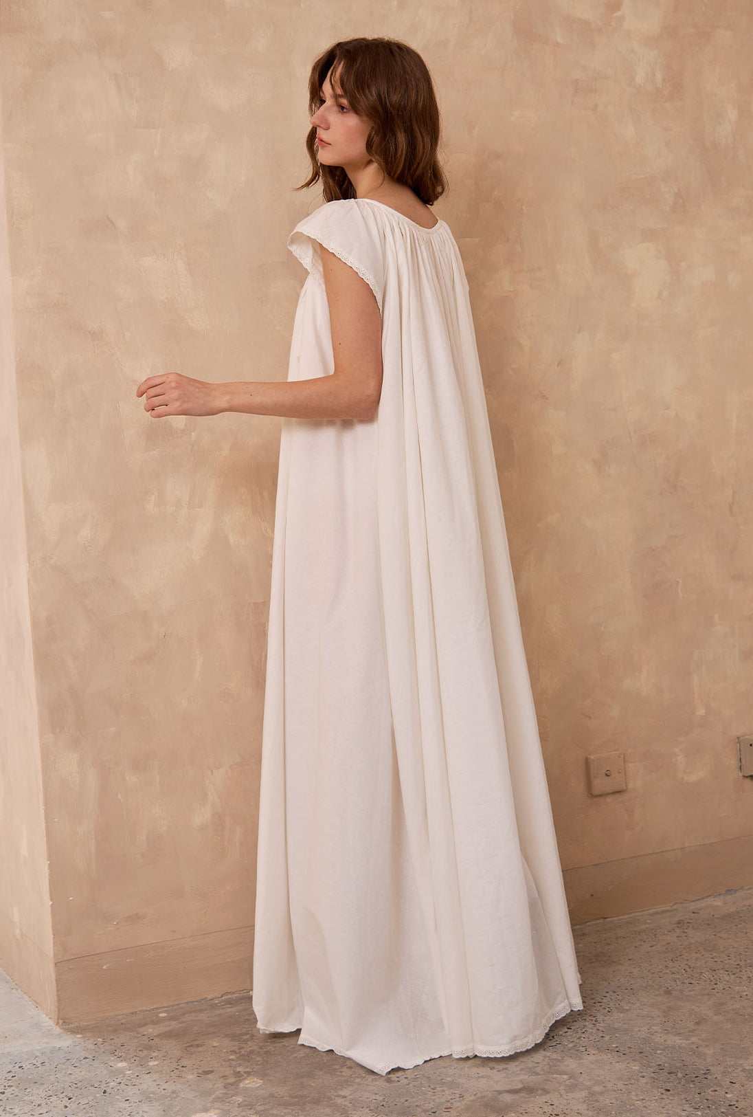 Back view of Sueasyretro ivory Victorian nightgown. Voluminous 100% cotton floor-length nightie with sleeveless lace.