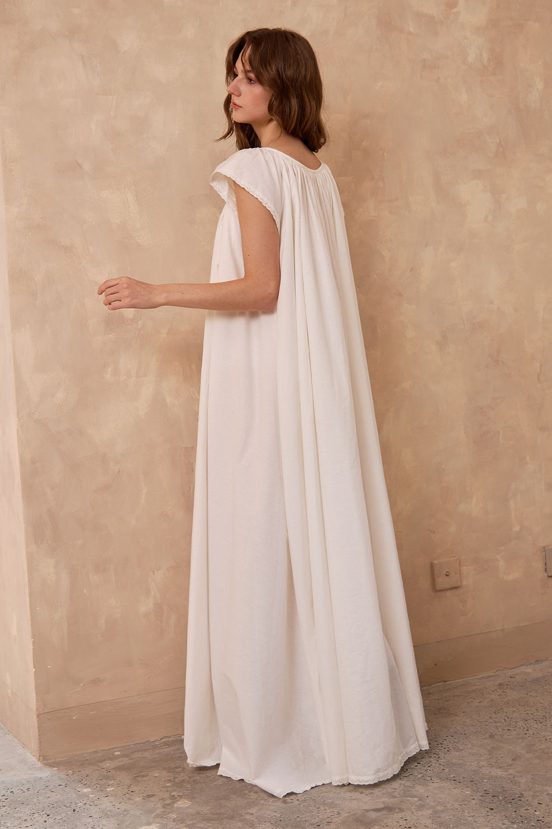 Back view of Sueasyretro ivory Victorian nightgown. Voluminous 100% cotton floor-length nightie with sleeveless lace.