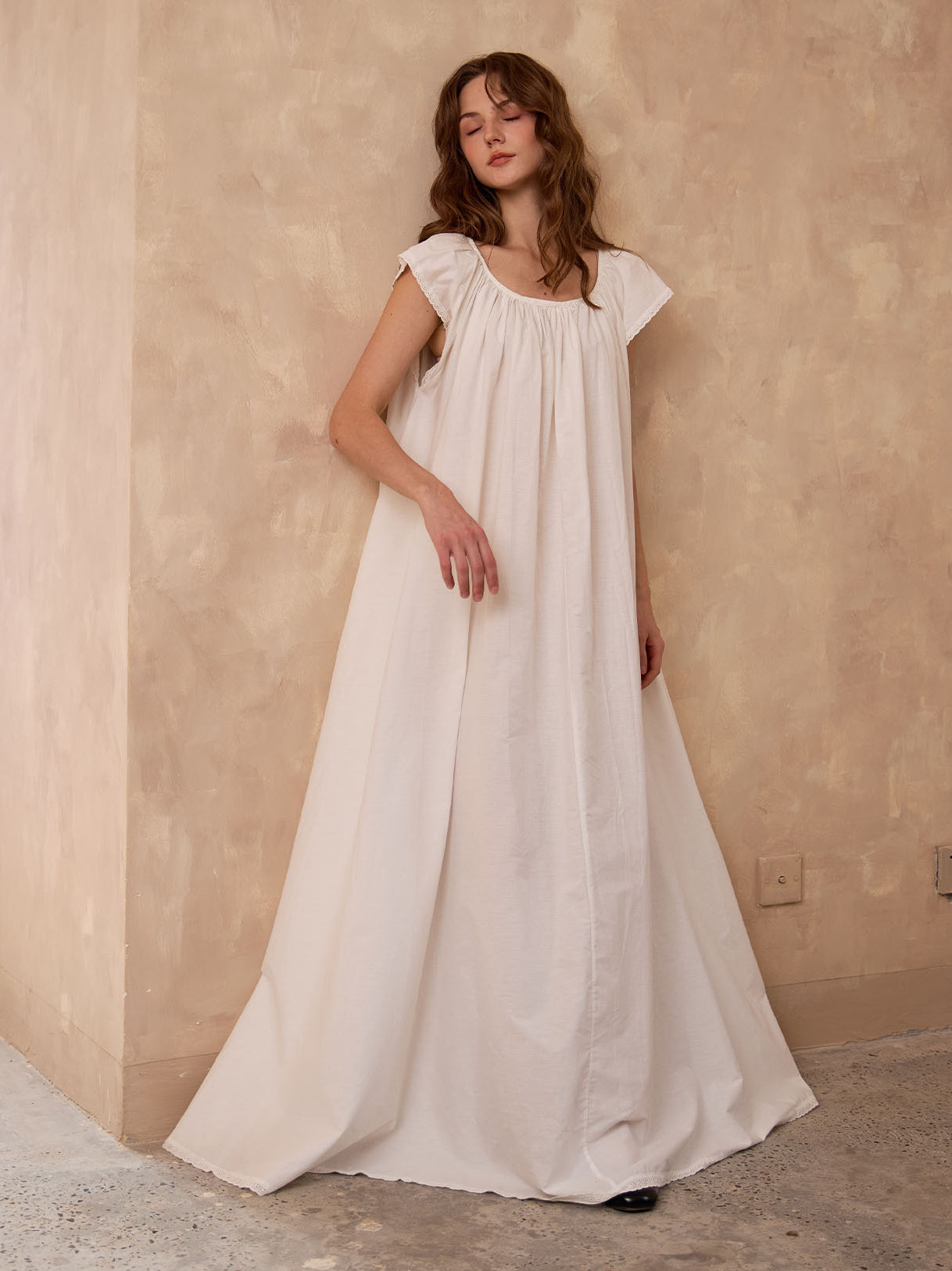 Relaxing in Sueasyretro ivory Victorian nightgown. Breathable sleeveless cotton nightie offering cloud-like comfort.