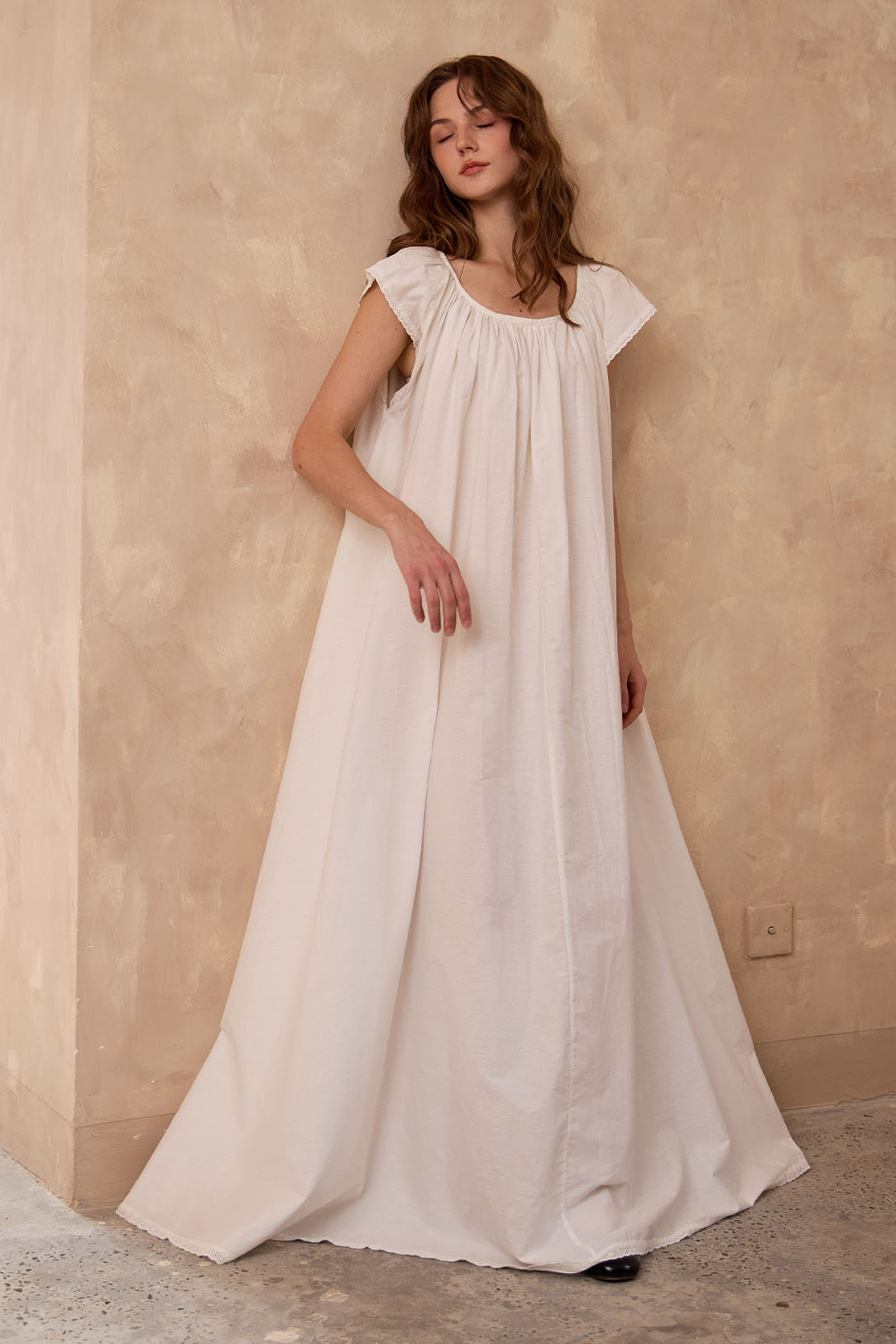 Relaxing in Sueasyretro ivory Victorian nightgown. Breathable sleeveless cotton nightie offering cloud-like comfort.