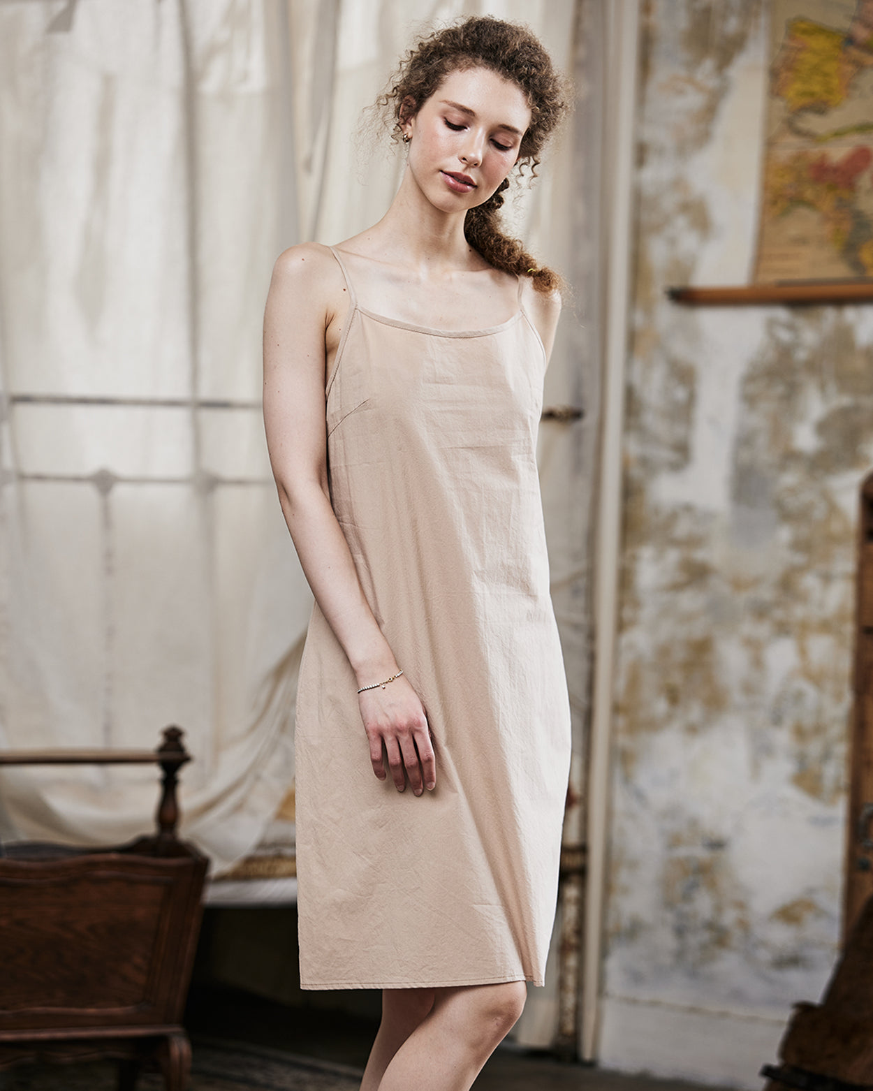 Women's nude cotton full slip with spaghetti straps, showing comfortable fit and classic design