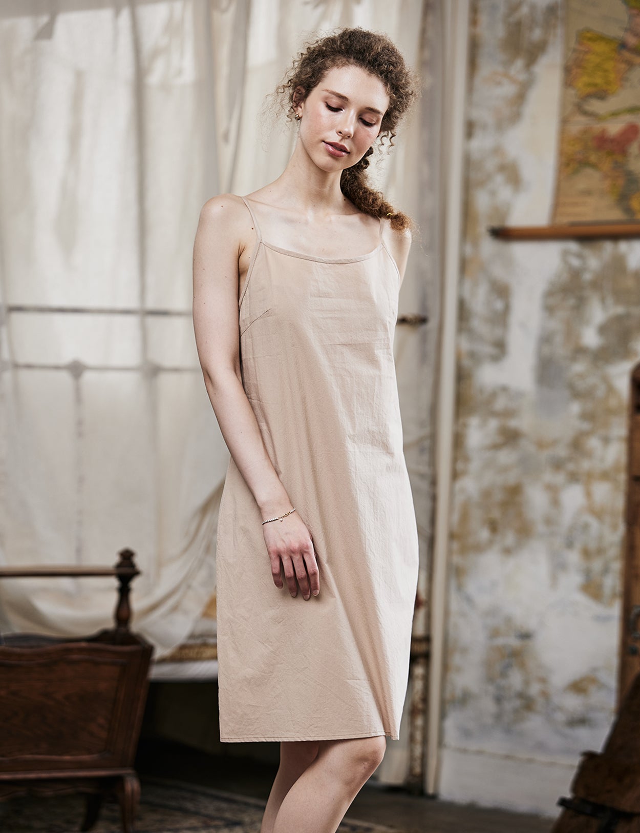 Women's nude cotton full slip with spaghetti straps, showing comfortable fit and classic design