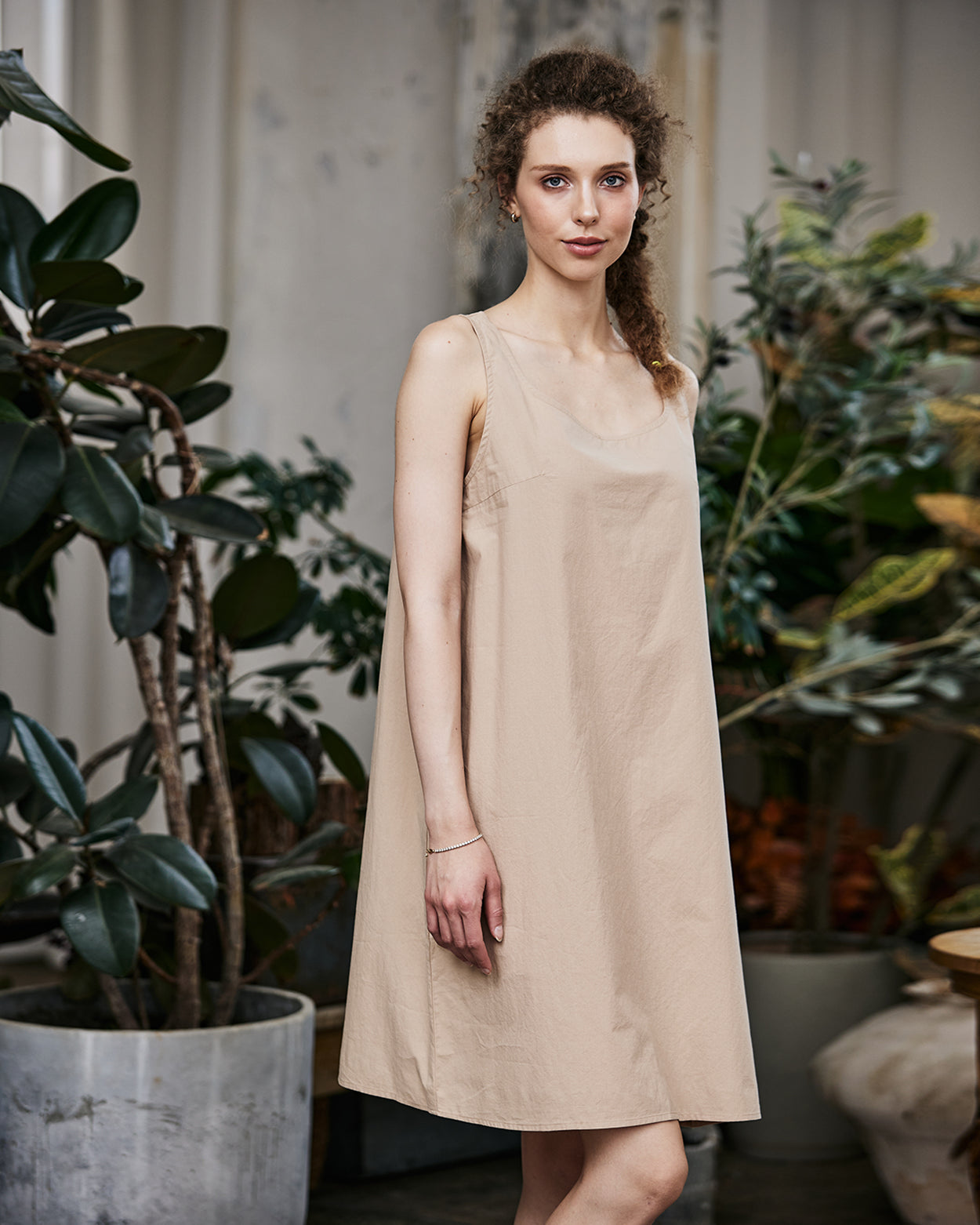 Women's nude cotton full slip with wide straps, showing modesty panel and knee-length design