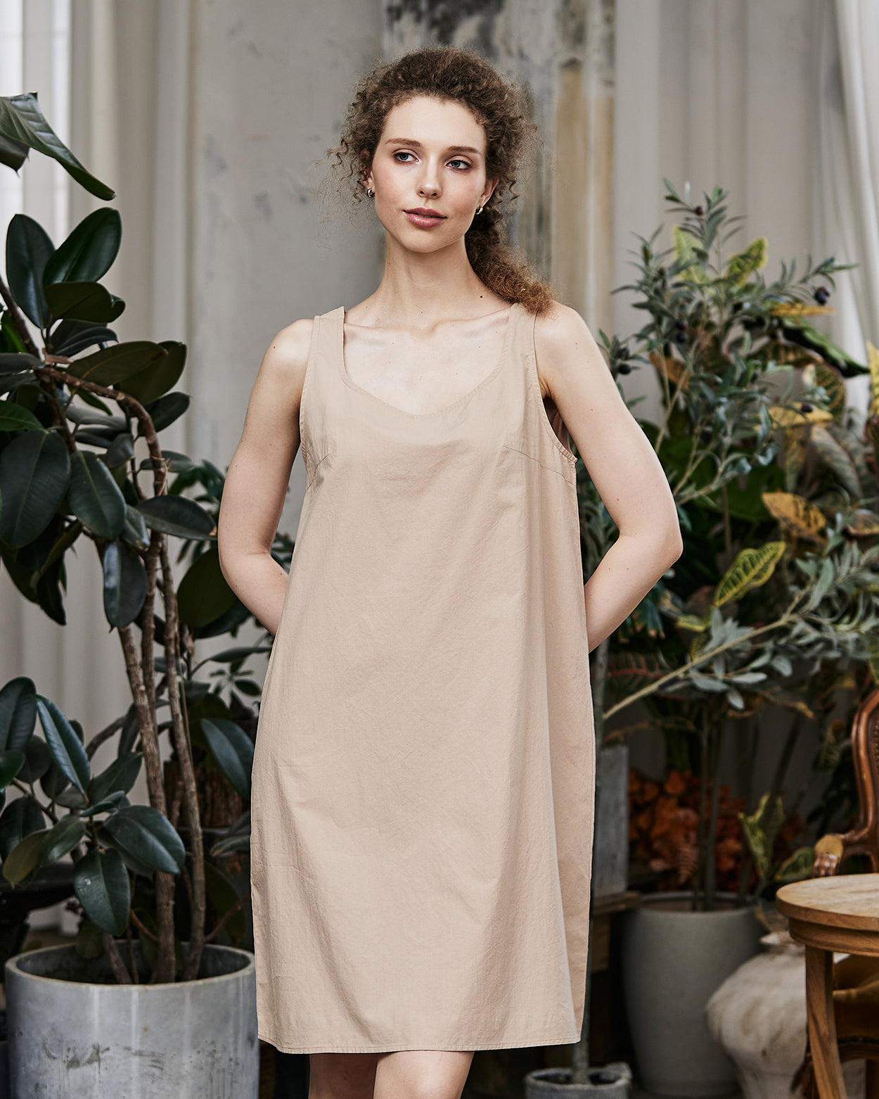 Women's nude cotton full slip with wide straps, showing modesty panel and knee-length design