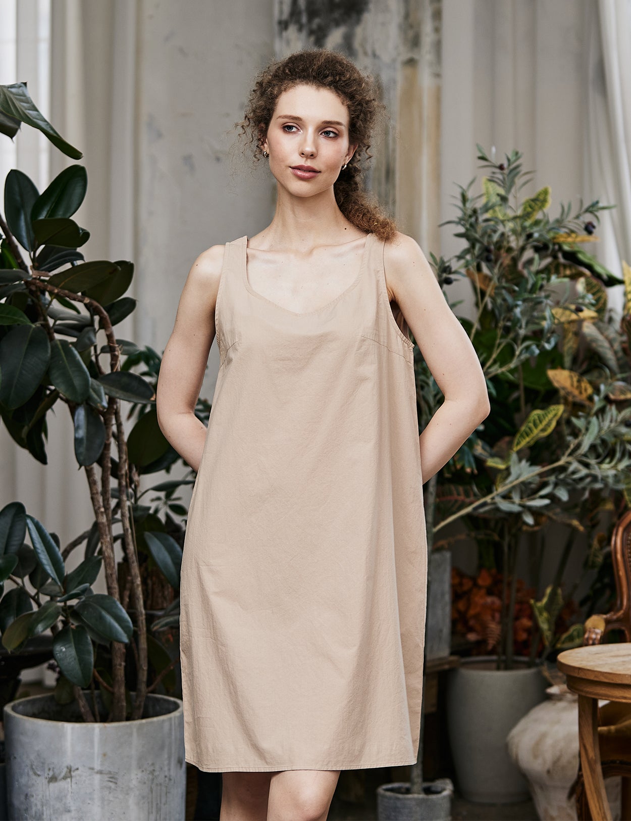 Women's nude cotton full slip with wide straps, showing modesty panel and knee-length design