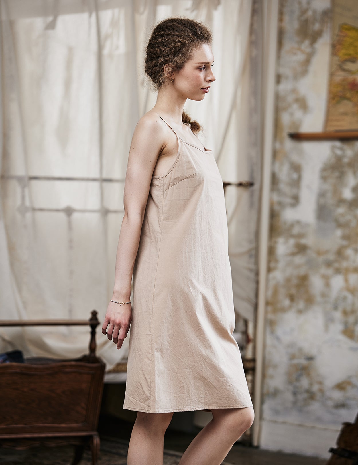 Women's nude cotton full slip with spaghetti straps, showing comfortable fit and classic design - side view