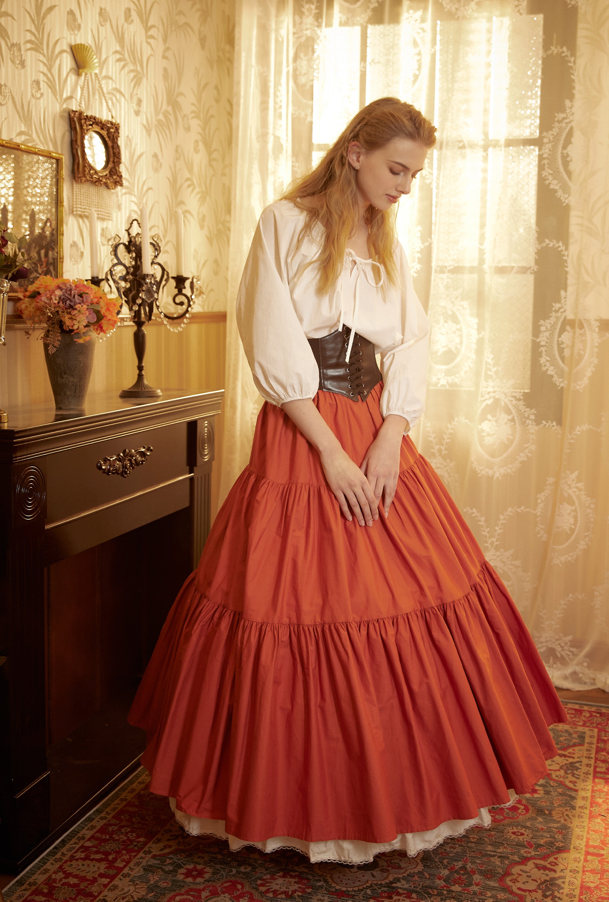 Front view close-up of a gathered orange skirt waistline, illustrating the voluminous flare created by the supportive 4-hoop cotton petticoat beneath.