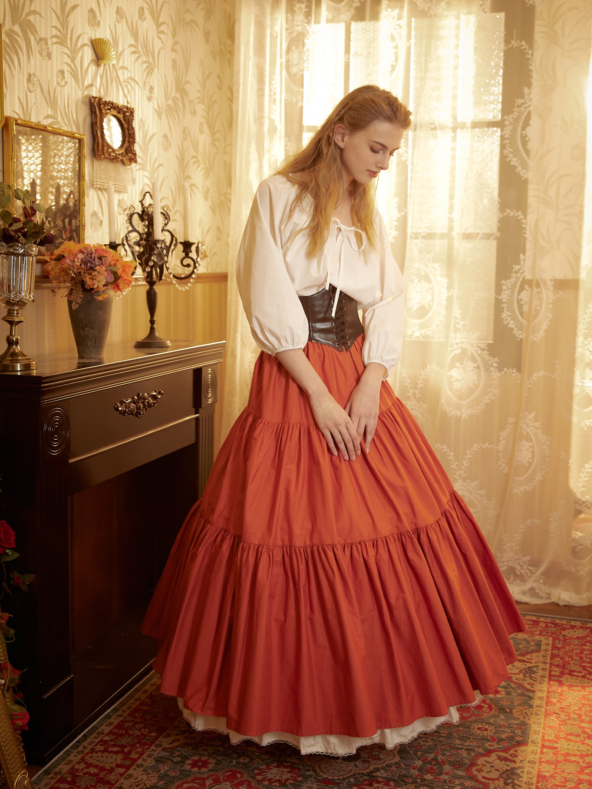 Front view close-up of a gathered orange skirt waistline, illustrating the voluminous flare created by the supportive 4-hoop cotton petticoat beneath.