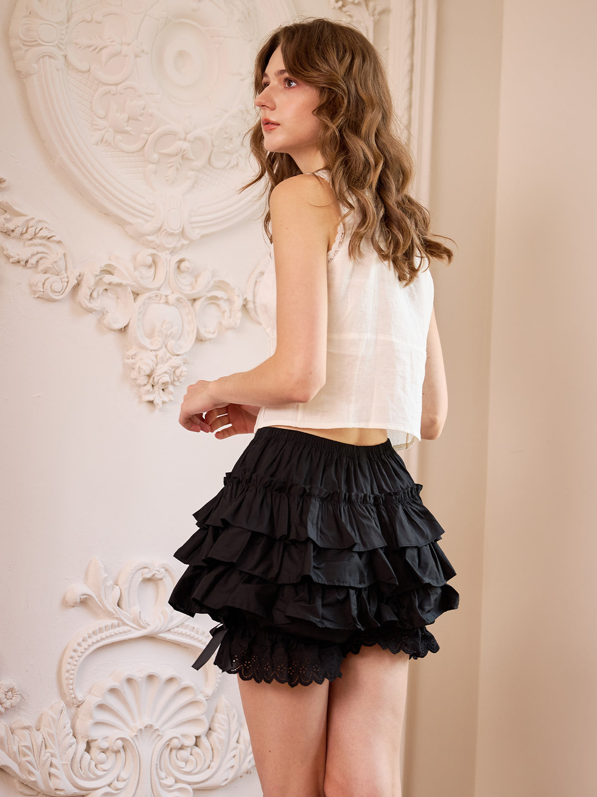 Back view of black bloomer shorts showing tiered ruffles and eyelet lace trim
