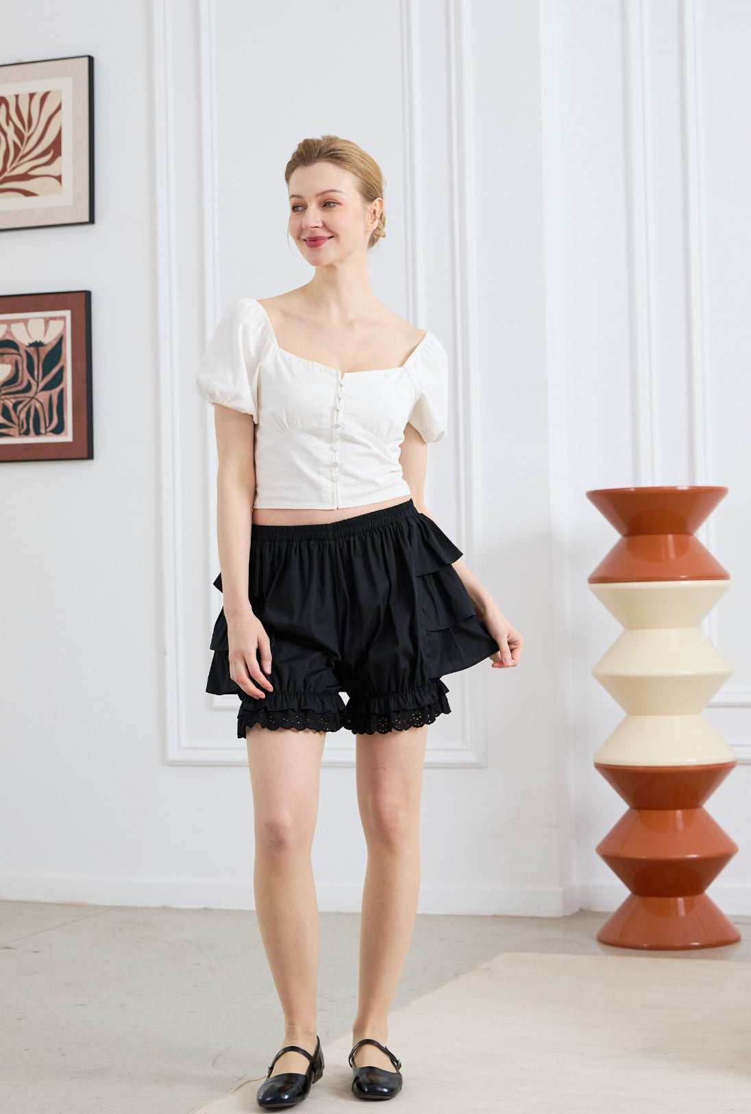 easyretro Black Cotton Ruffle Bloomer Shorts. Front view of model wearing the shorts and matching top.