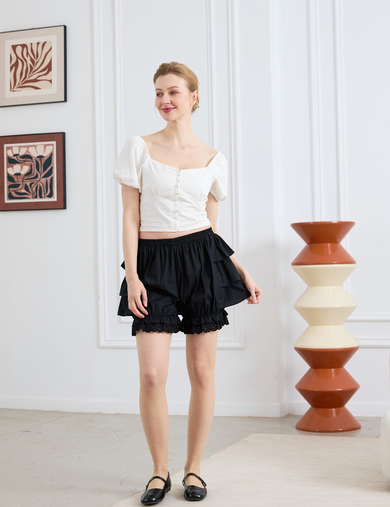 easyretro Black Cotton Ruffle Bloomer Shorts. Front view of model wearing the shorts and matching top.