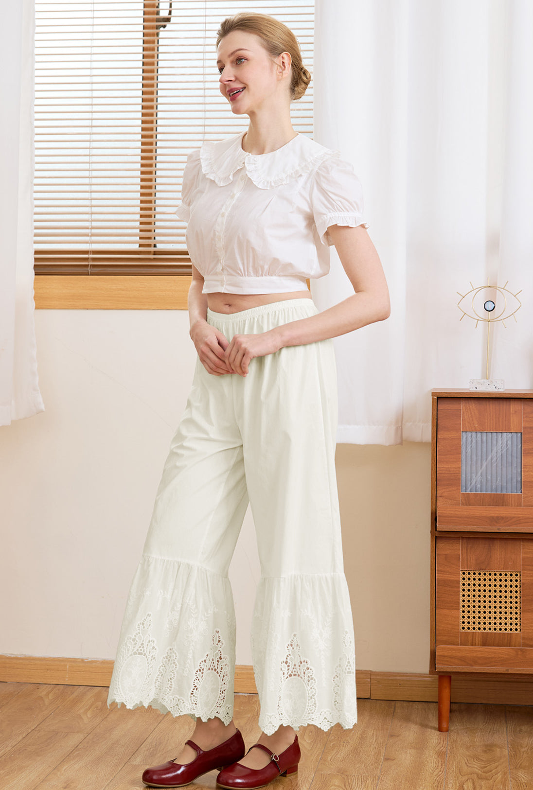 Side view of Sueasyretro cream 100% cotton lace bloomers, worn as relaxed everyday vintage trousers.