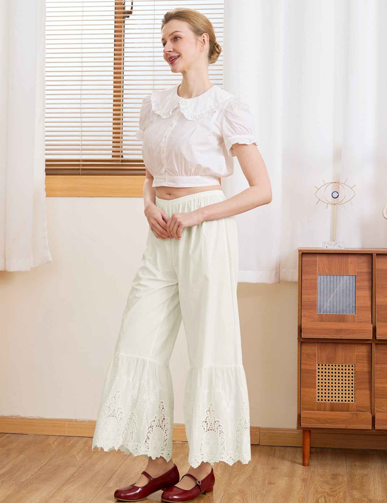 Side view of Sueasyretro cream 100% cotton lace bloomers, worn as relaxed everyday vintage trousers.