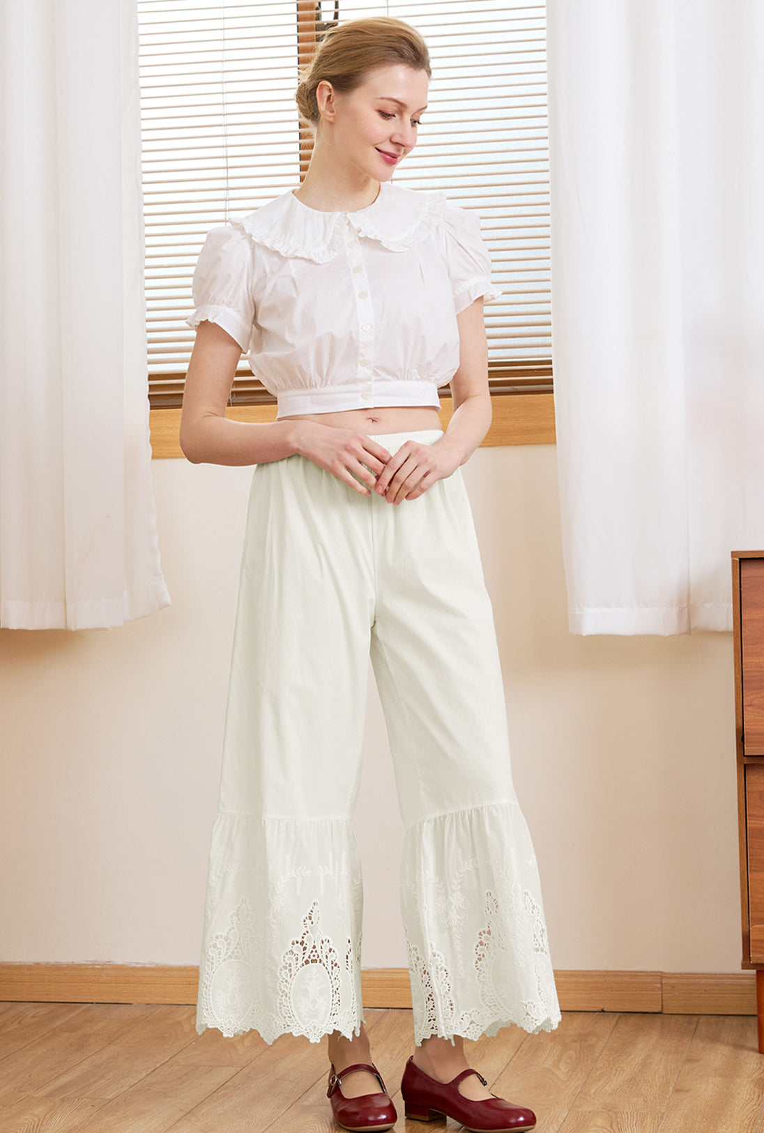 Woman wearing Sueasyretro cream vintage bloomer pants in 100% cotton for a relaxed, romantic look.