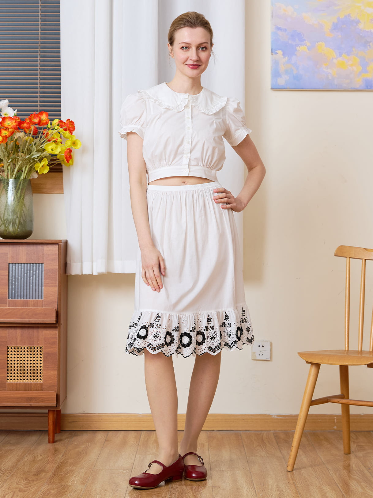 Tudor-Inspired Half Slip: full front view of cotton skirt extender with black floral hem styled in a retro room.